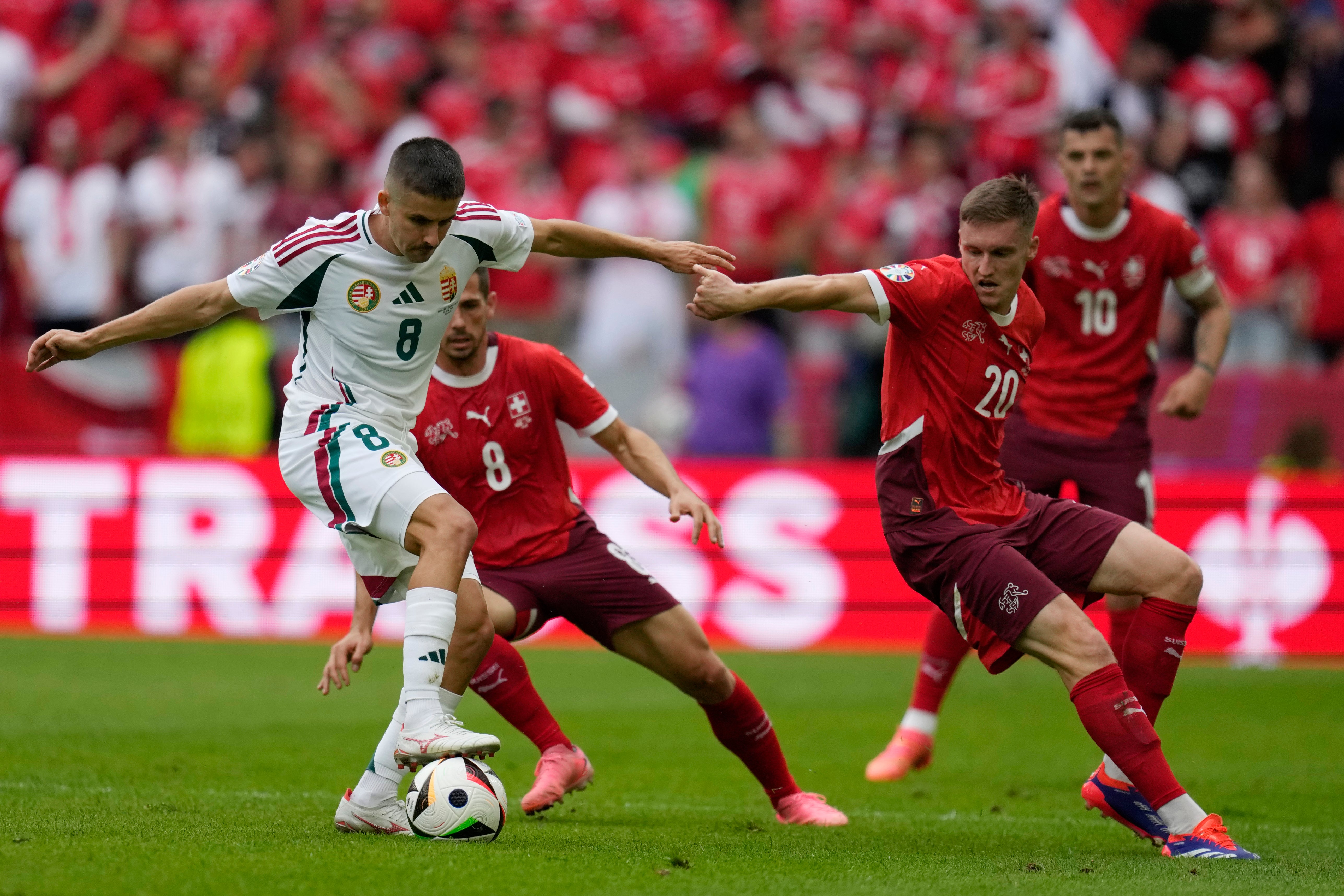 Hungary's Adam Nagy, left, challenges for the ball with Switzerland's Michel Aebischer