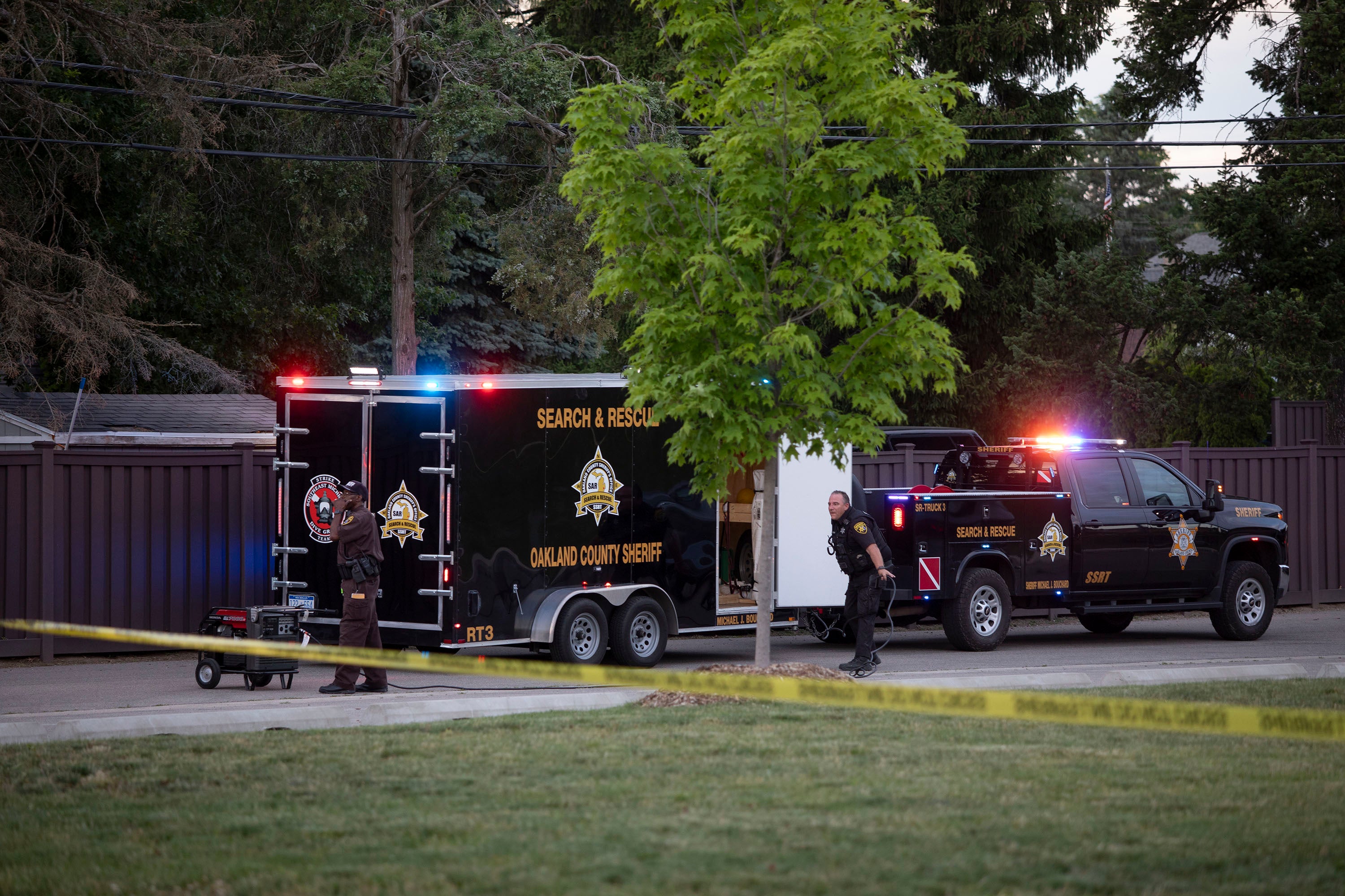 Police investigate the scene of the shooting at the Brooklands Plaza Splash Pad in Rochester Hills, Michigan on Saturday. One victim, an eight-year-old boy was shot in the head.