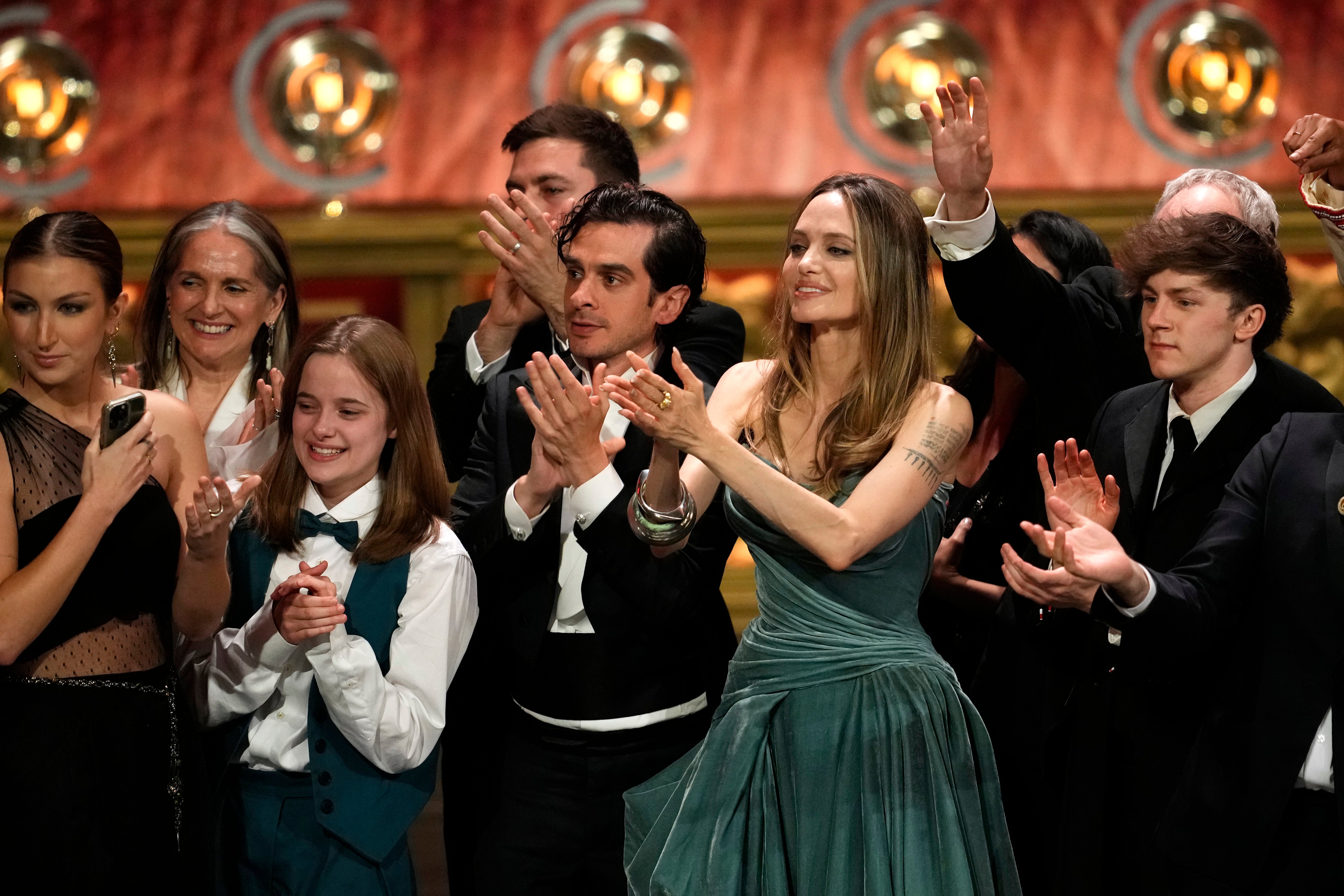 Vivienne Jolie, Justin Levine, Angelina Jolie, Brody Grant and members of the company of ‘The Outsiders’ at the 77th Tony Awards