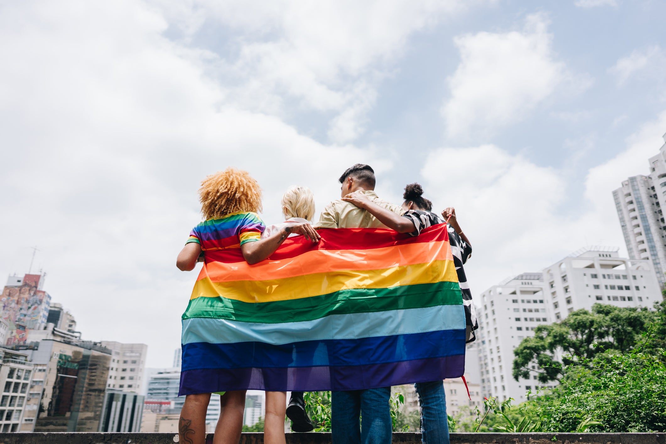 You don’t have to wrap yourself in a rainbow flag to be an LGBTQ+ ally as a straight person at pride — although you can!