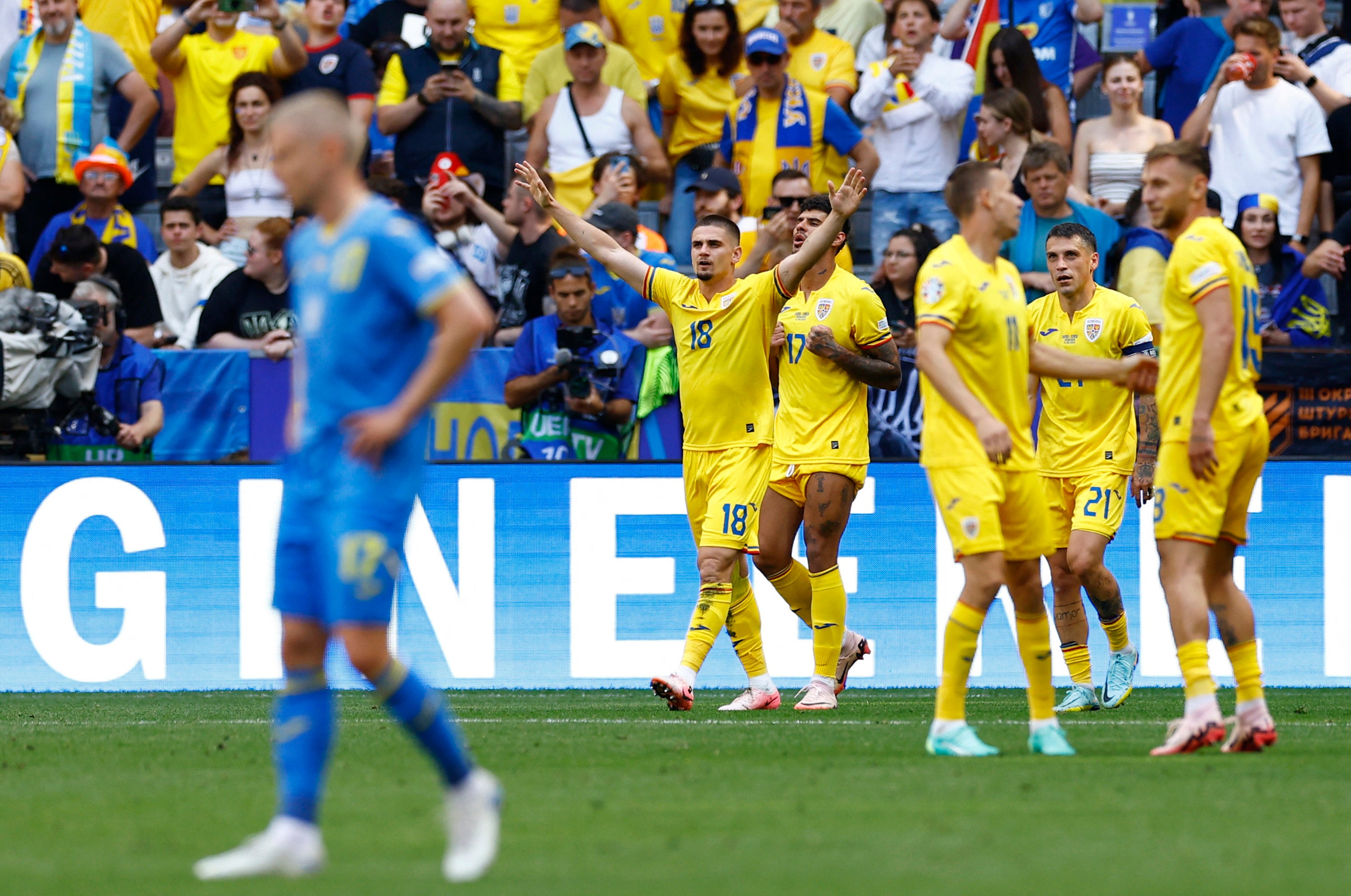 Romania’s Razvan Marin (18) celebrates scoring their second goal