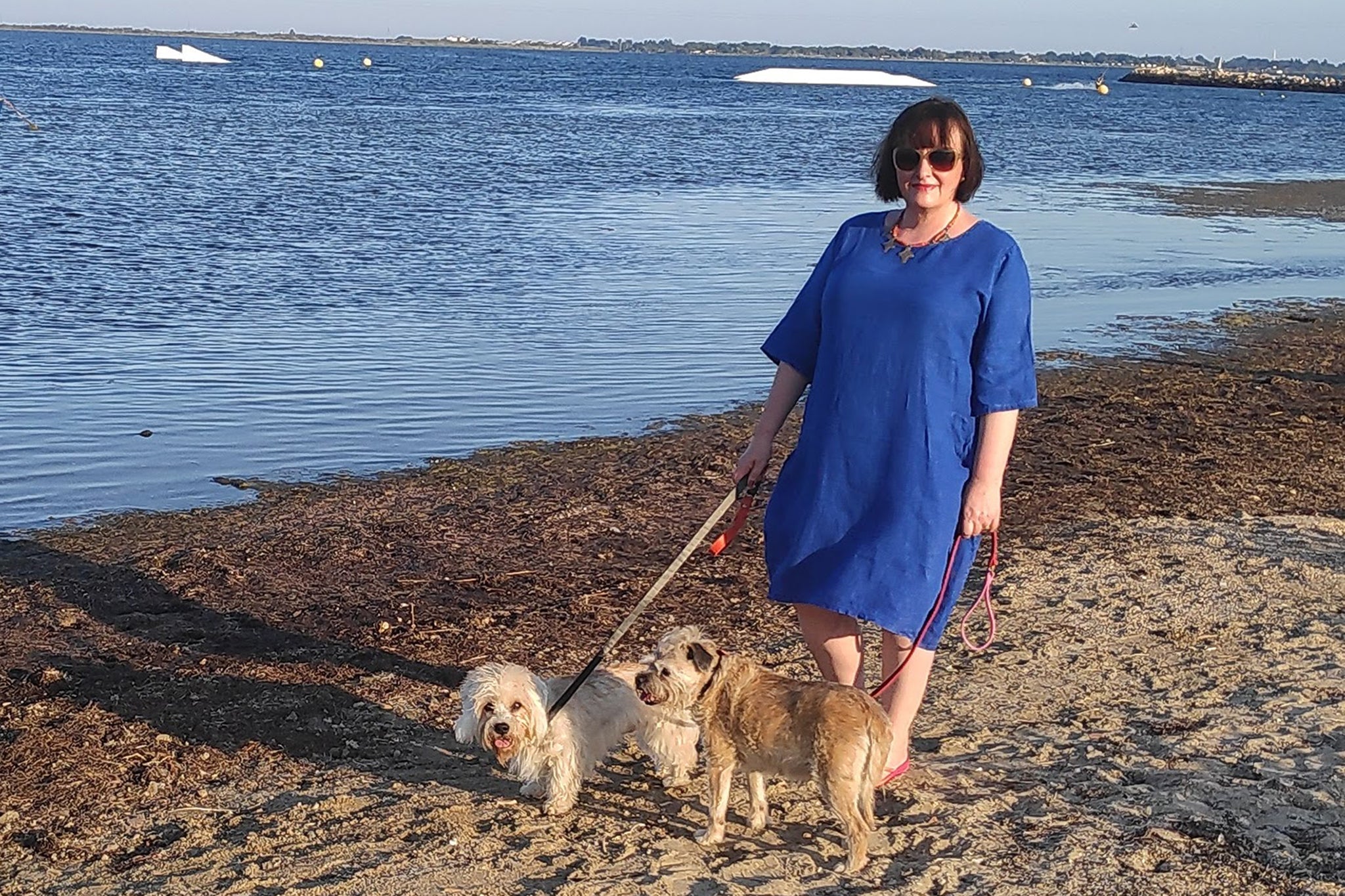 Debora Robertson with her dogs Barney and Gracie on the beach