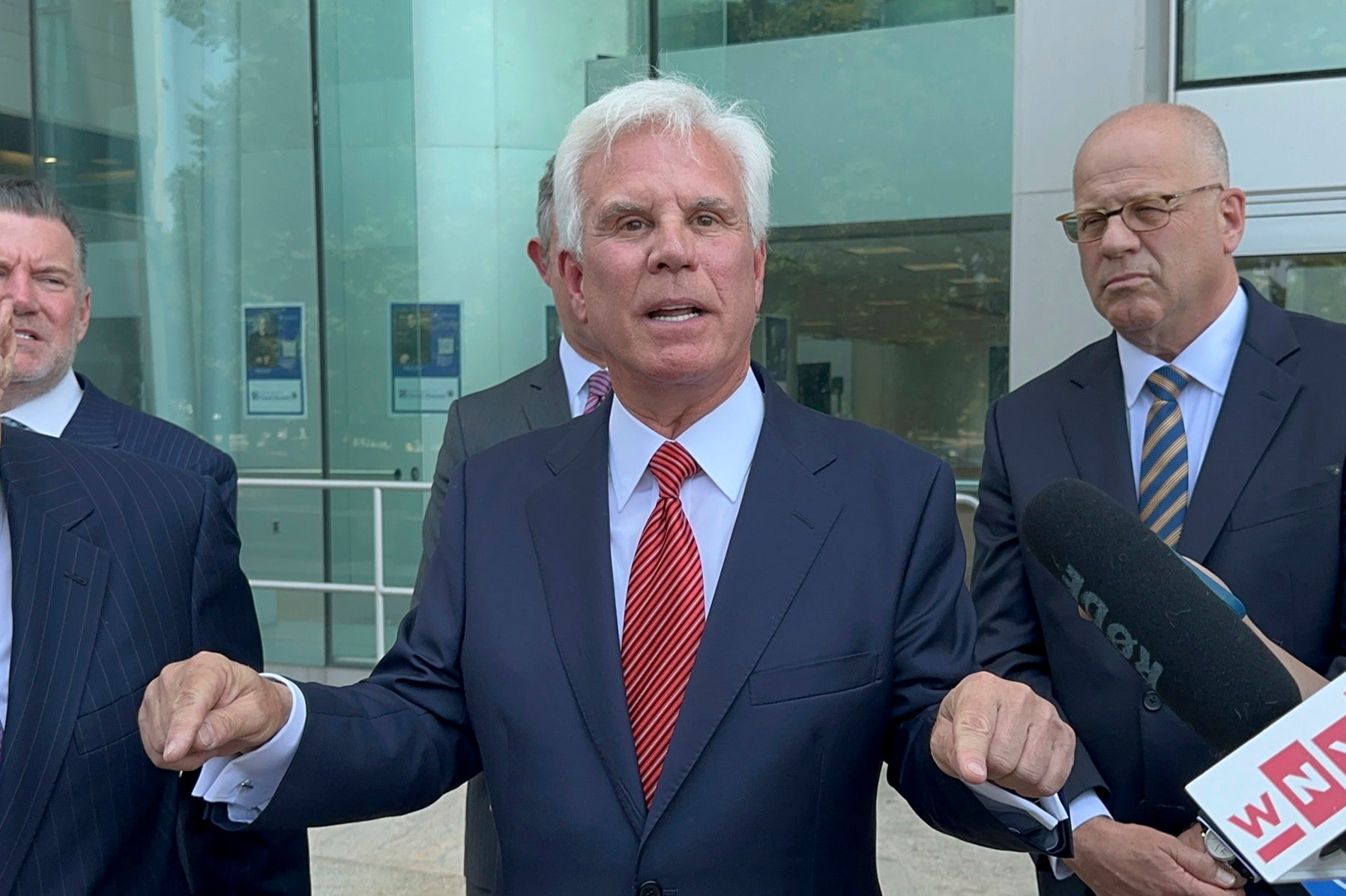 Influential Democratic power broker George Norcross, center, speaks outside the justice complex in Trenton, NJ Monday, June 17, 2024,