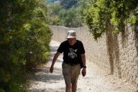 A person walks at the village of Rovinia on the island of Corfu