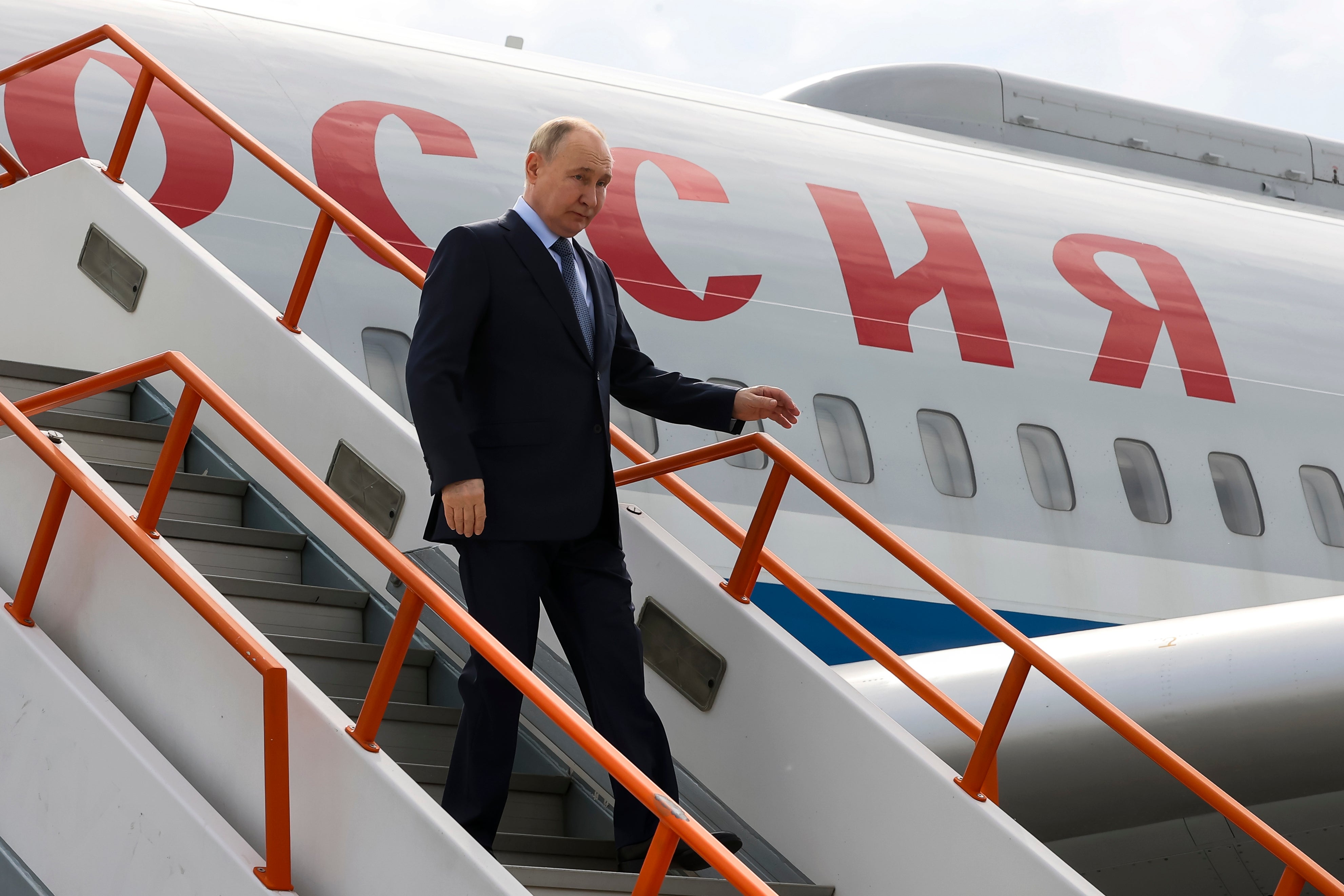 Putin goes down the stairs upon his arrival at the airport of Yakutsk, republic of Sakha, in the east of Russia, today