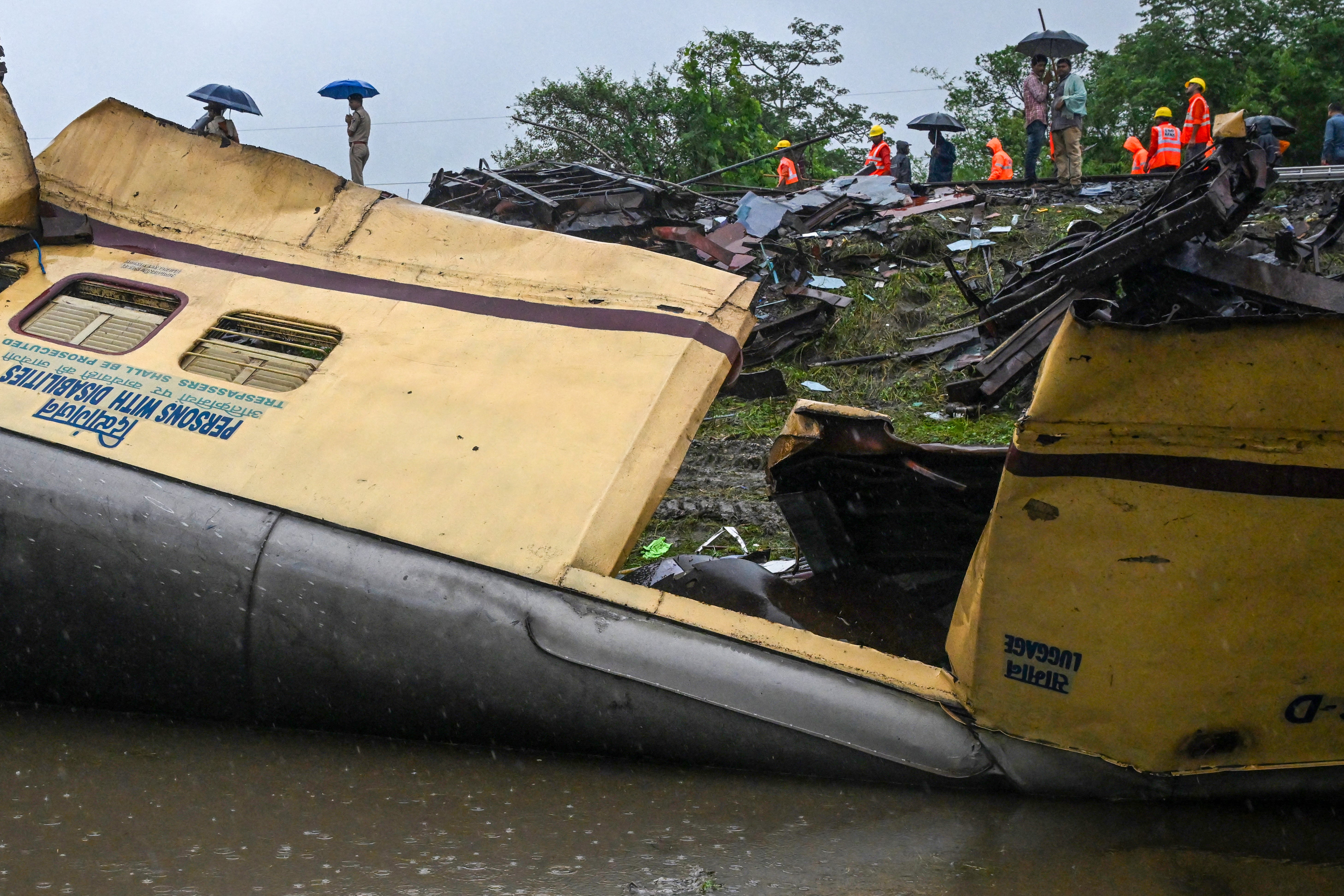 Railway workers inspect the wreckage of the Kanchenjunga Express train