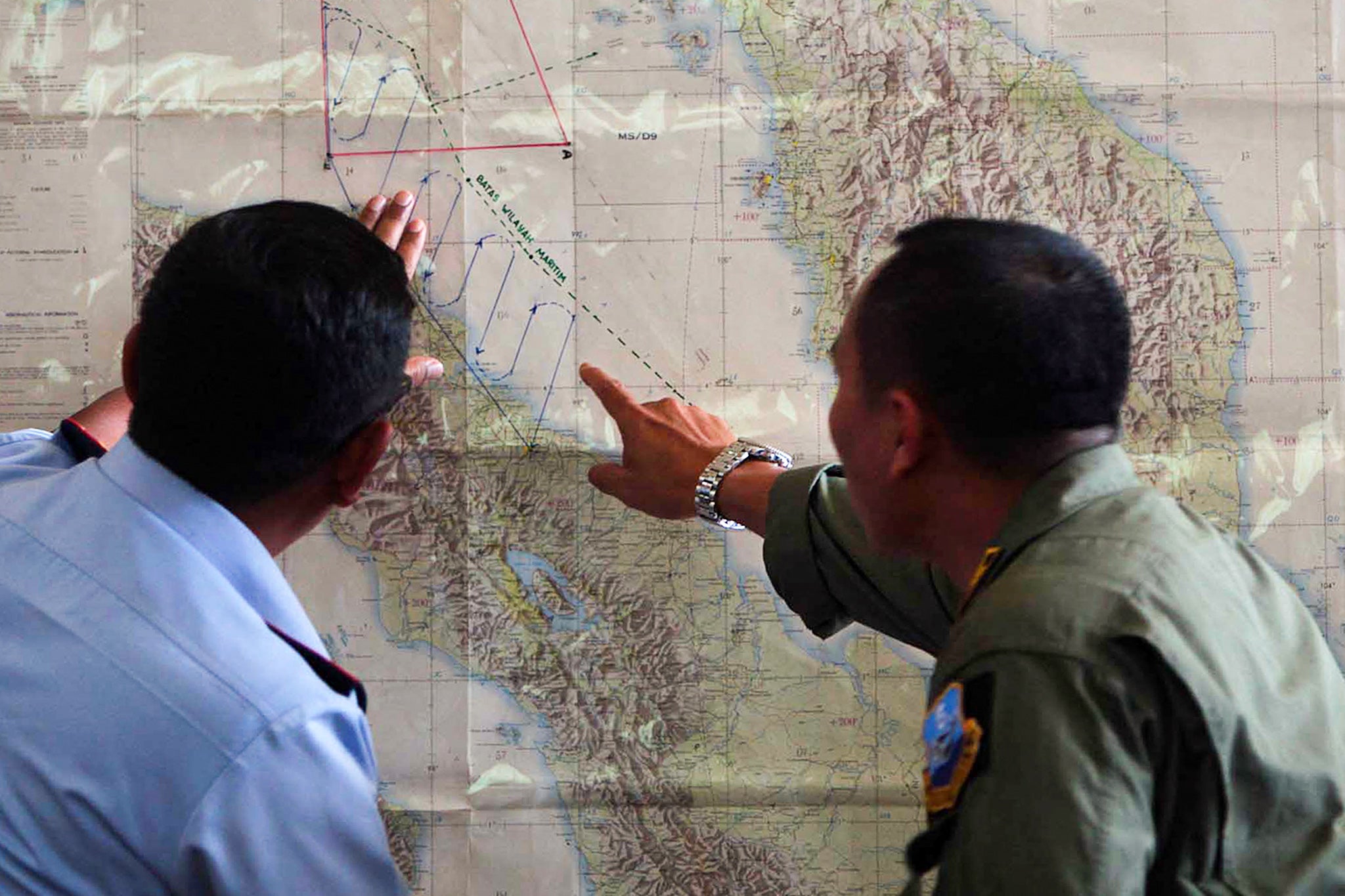 Indonesian Air Force officials plot a search operation for MH370 in 2014