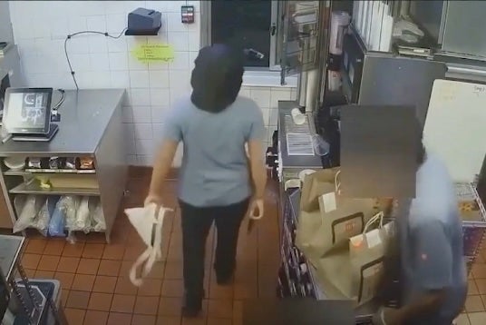 A McDonald’s employee is seen with a gun before shooting at a drive-thru customer