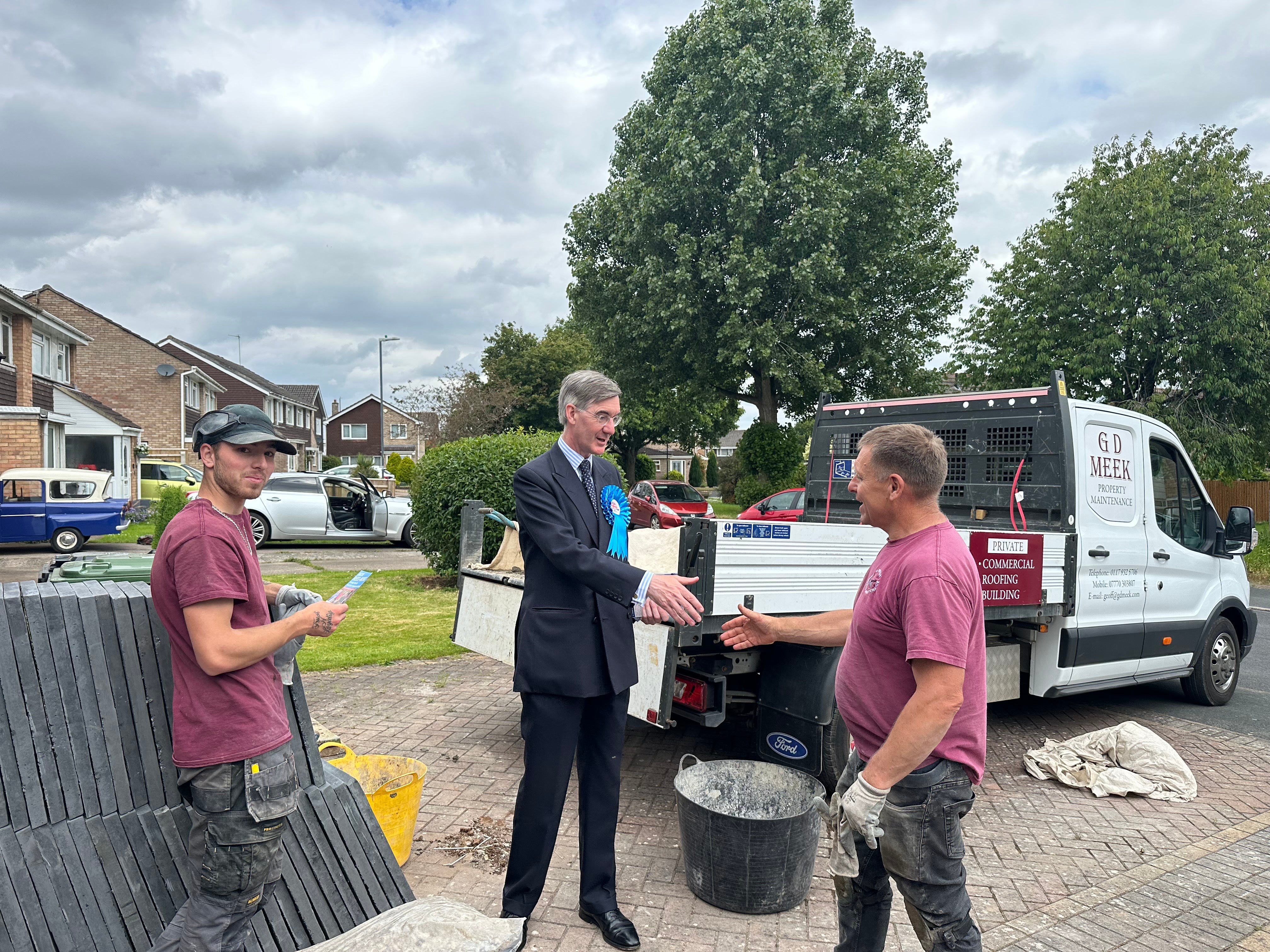 Voter Geoff Meek shakes Sir Jacob’s hand during canvassing in Longwell Green