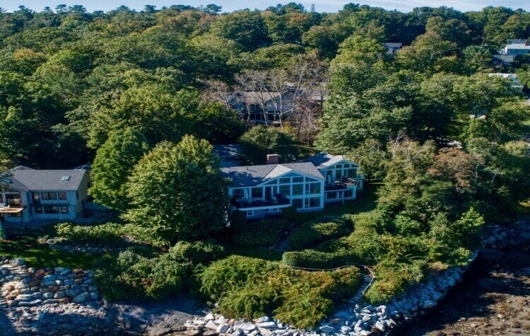 Trees in front of the waterfront home of Lisa Gorman (foreground) were poisoned by her nighbour Amelia Bond, so that the oceanview from her property (behind) could be cleared