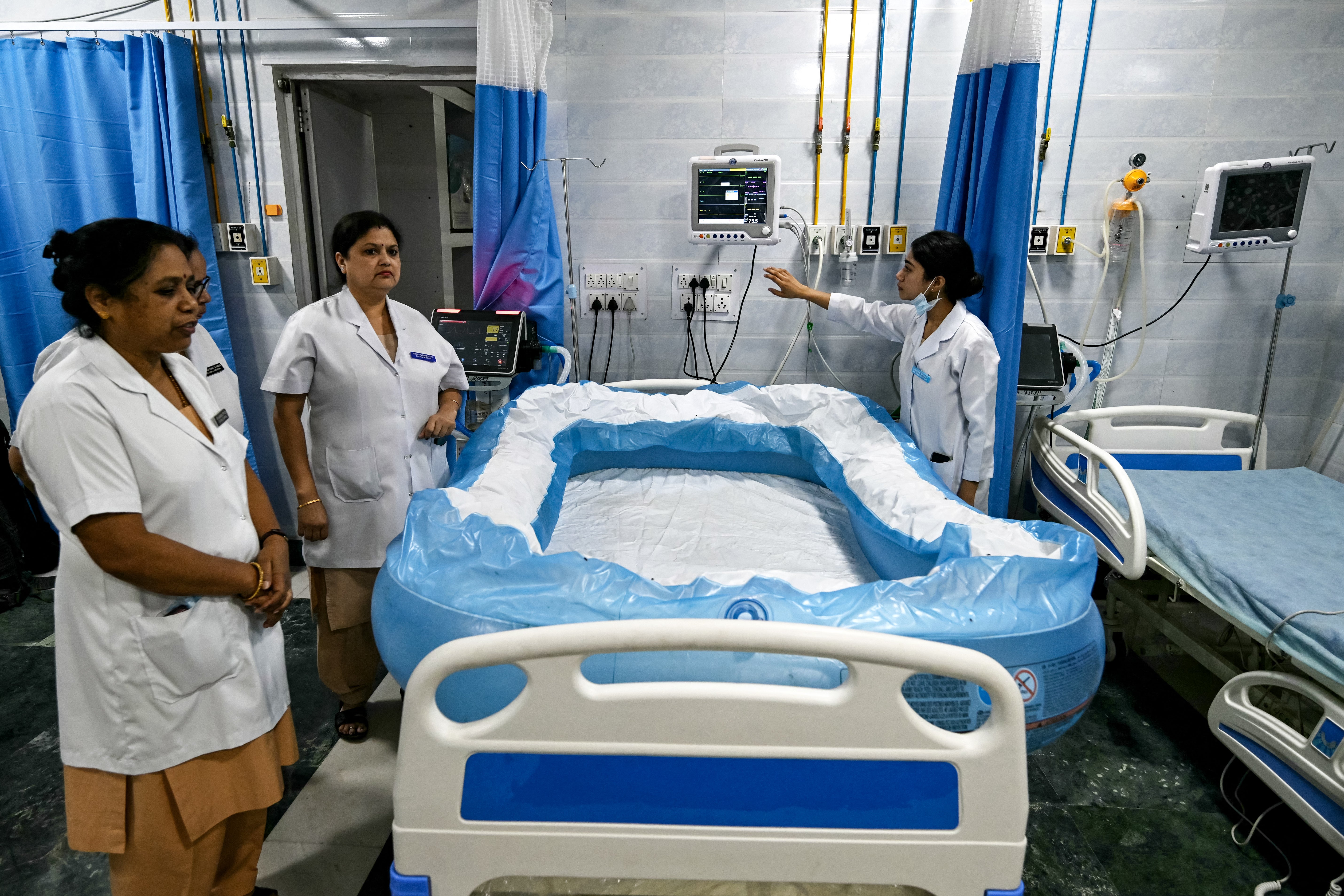 Staff prepare an inflated ice bed in the heatstroke ward of Ram Manohar Lohia hospital in Delhi