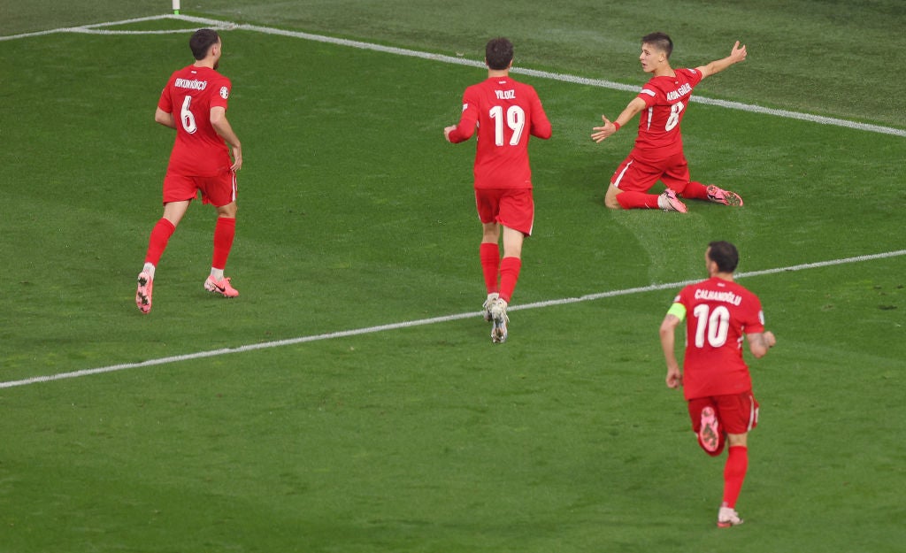 Guler celebrates after scoring for Turkey