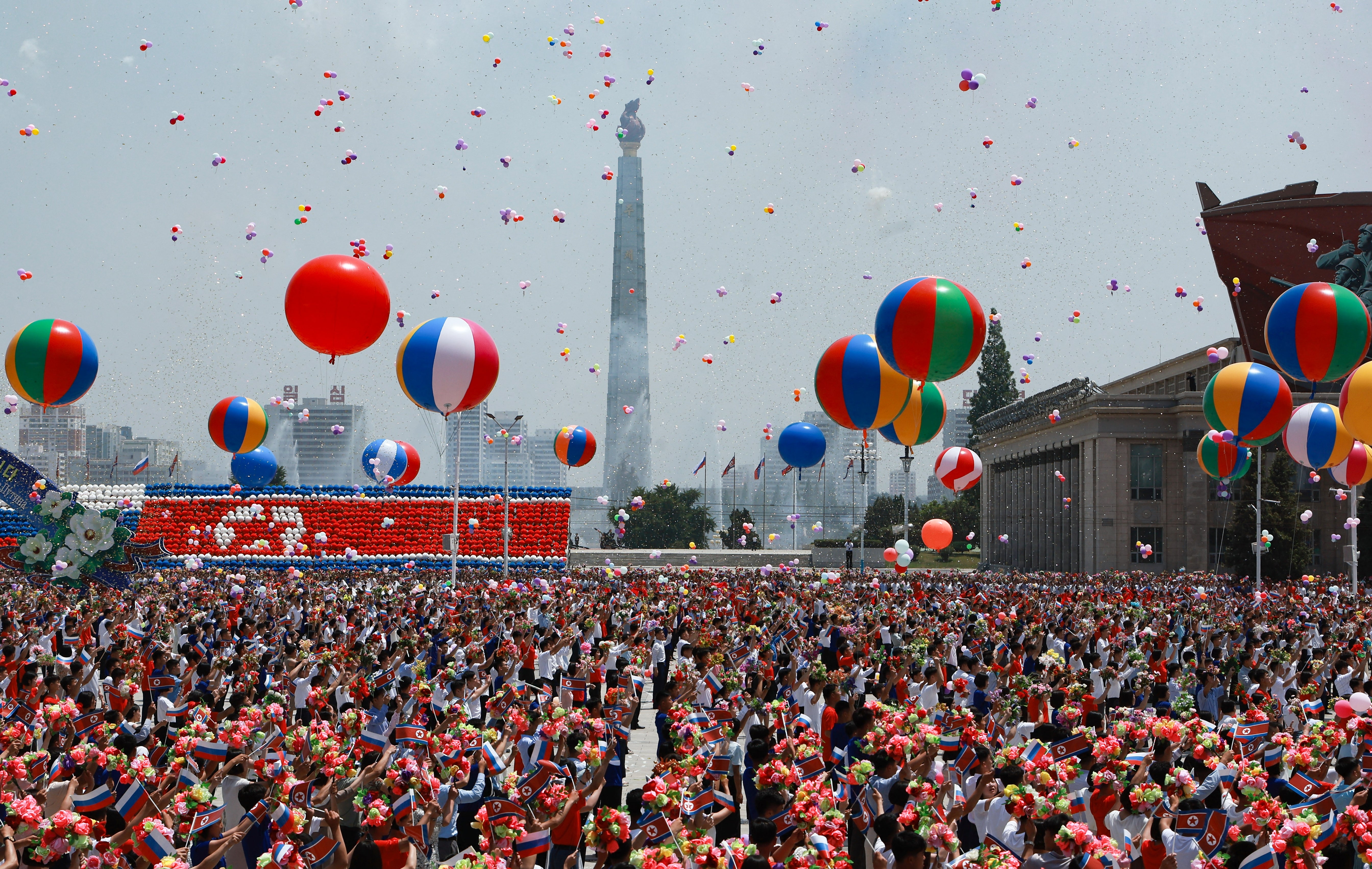 People release balloons in the air as Russia's president Vladimir Putin and North Korea's leader Kim Jong-un attend a welcoming ceremony at Kim Il Sung Square in Pyongyang on June 19, 2024