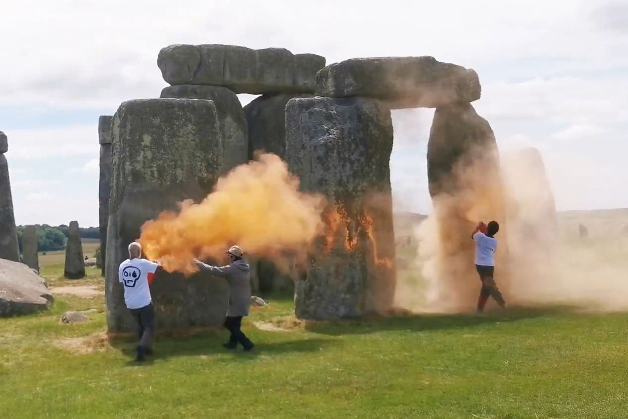 Screen grab taken from handout video of Just Stop Oil protesters spraying an orange substance on Stonehenge (Just Stop Oil/PA)