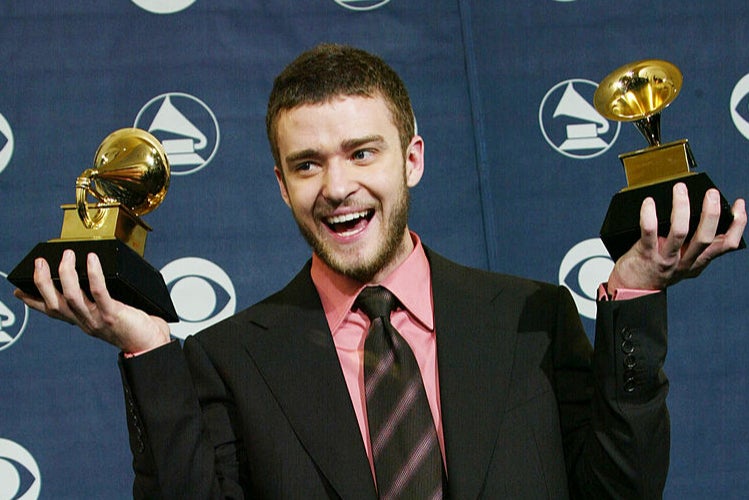 Timberlake in his heyday in 2004, posing with two Grammy awards