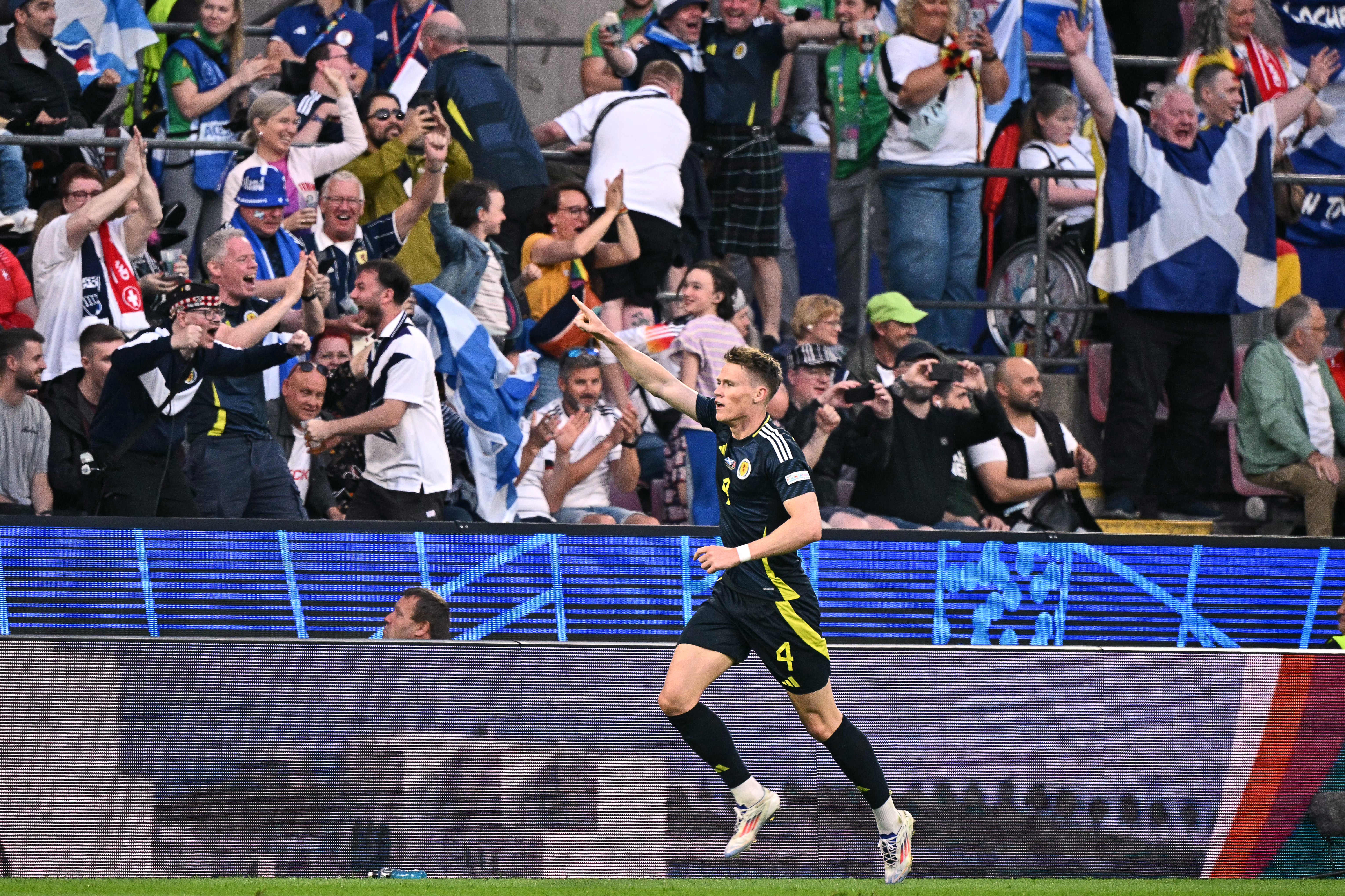 Scott McTominay celebrates with Scottish fans