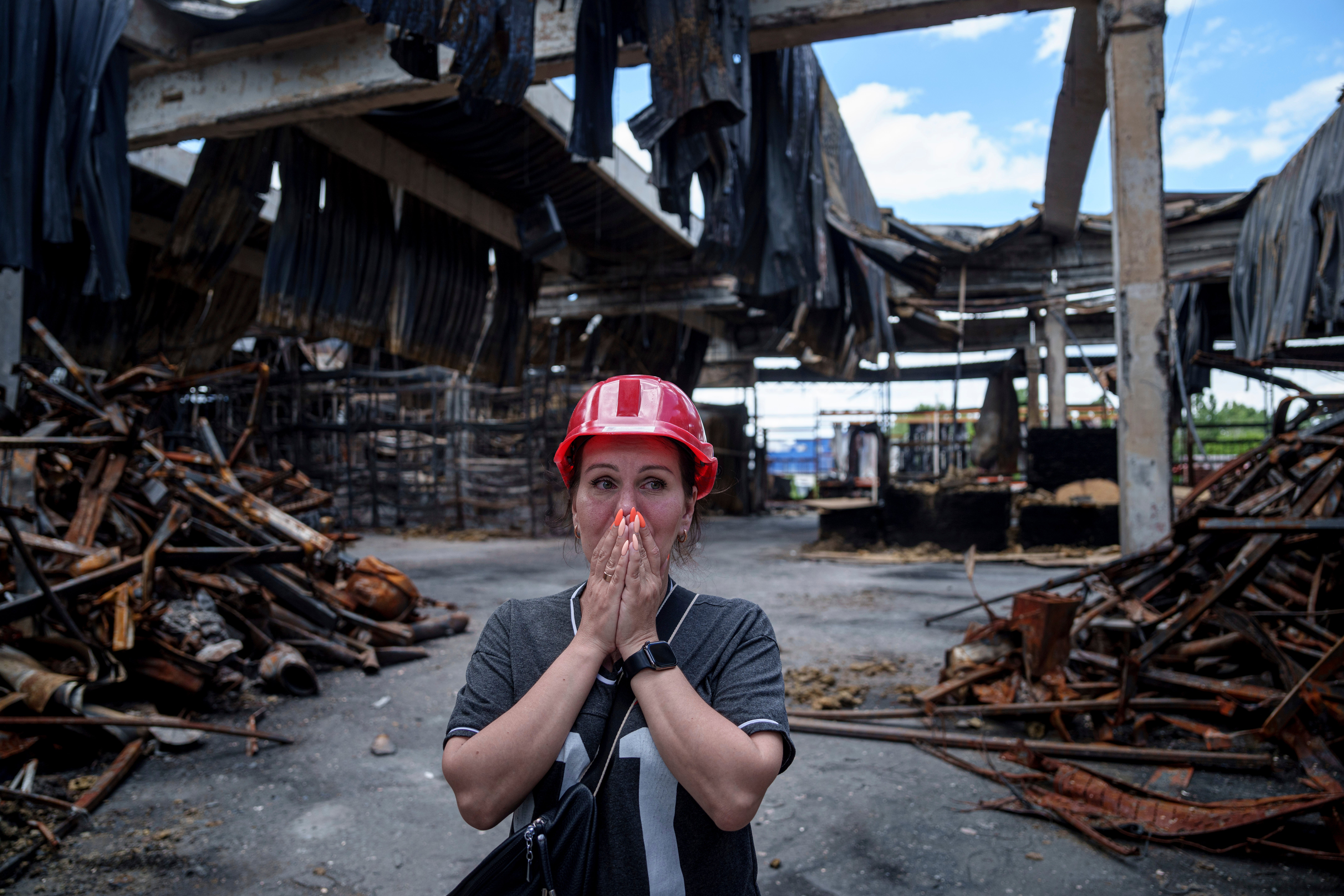 Nina Korsunova gets emotional as she walks inside the destroyed Epicenter shopping complex in Kharkiv, Ukraine, hit by Russian glide bombs earlier this month. At least 11 people were killed