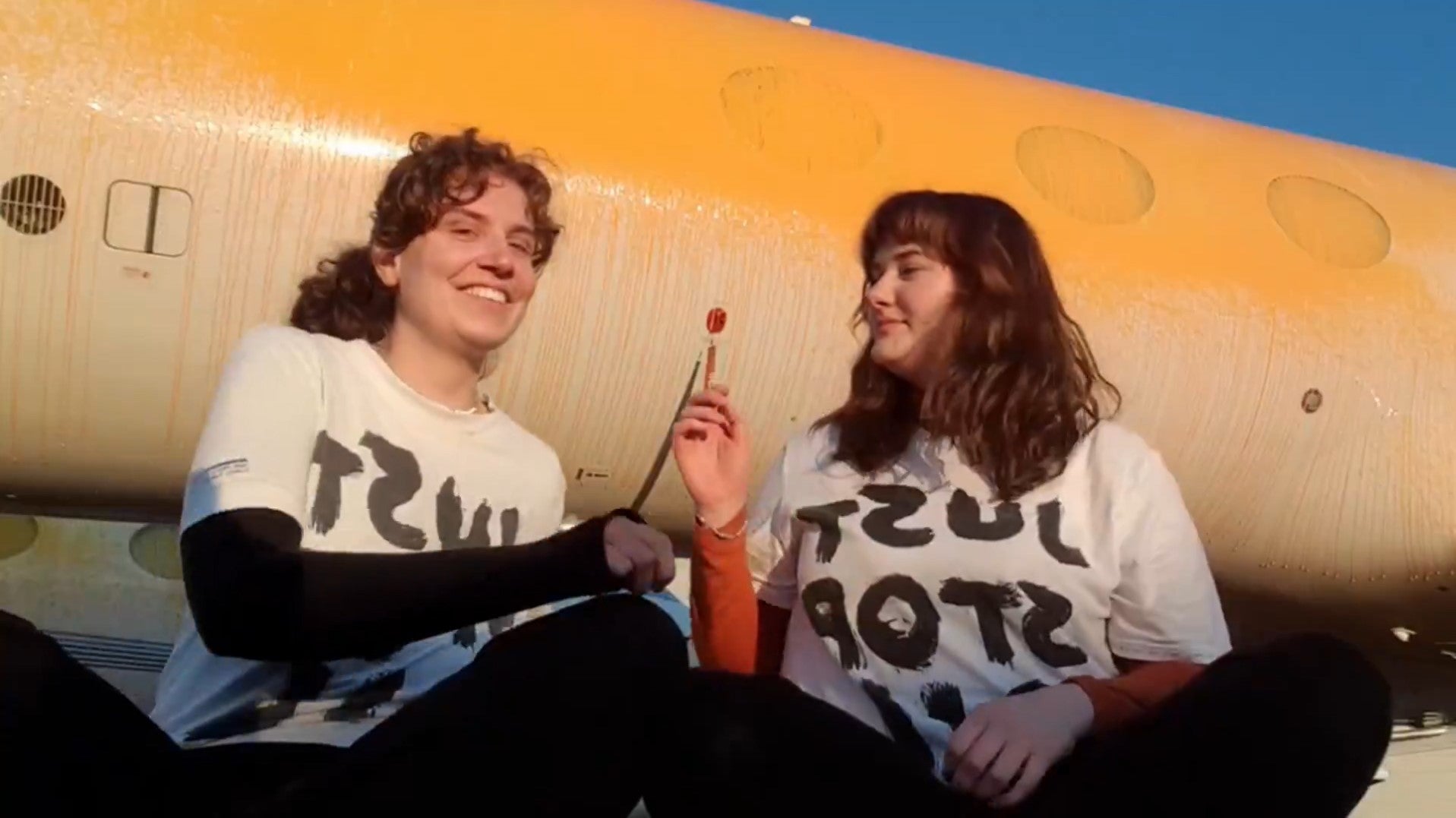 Just Stop Oil protesters after they sprayed orange paint over parked private jets at London Stansted