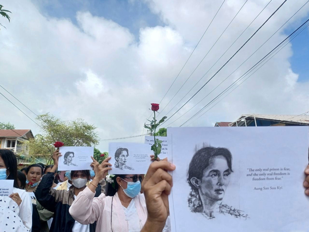 Demonstrators hold papers printed with Aung San Suu Kyi’s famous quote ‘The only real prison is fear, and the only real freedom is freedom from fear’ as they rally to mark her 79th birthday in Launglon township in Tanintharyi region, Myanmar