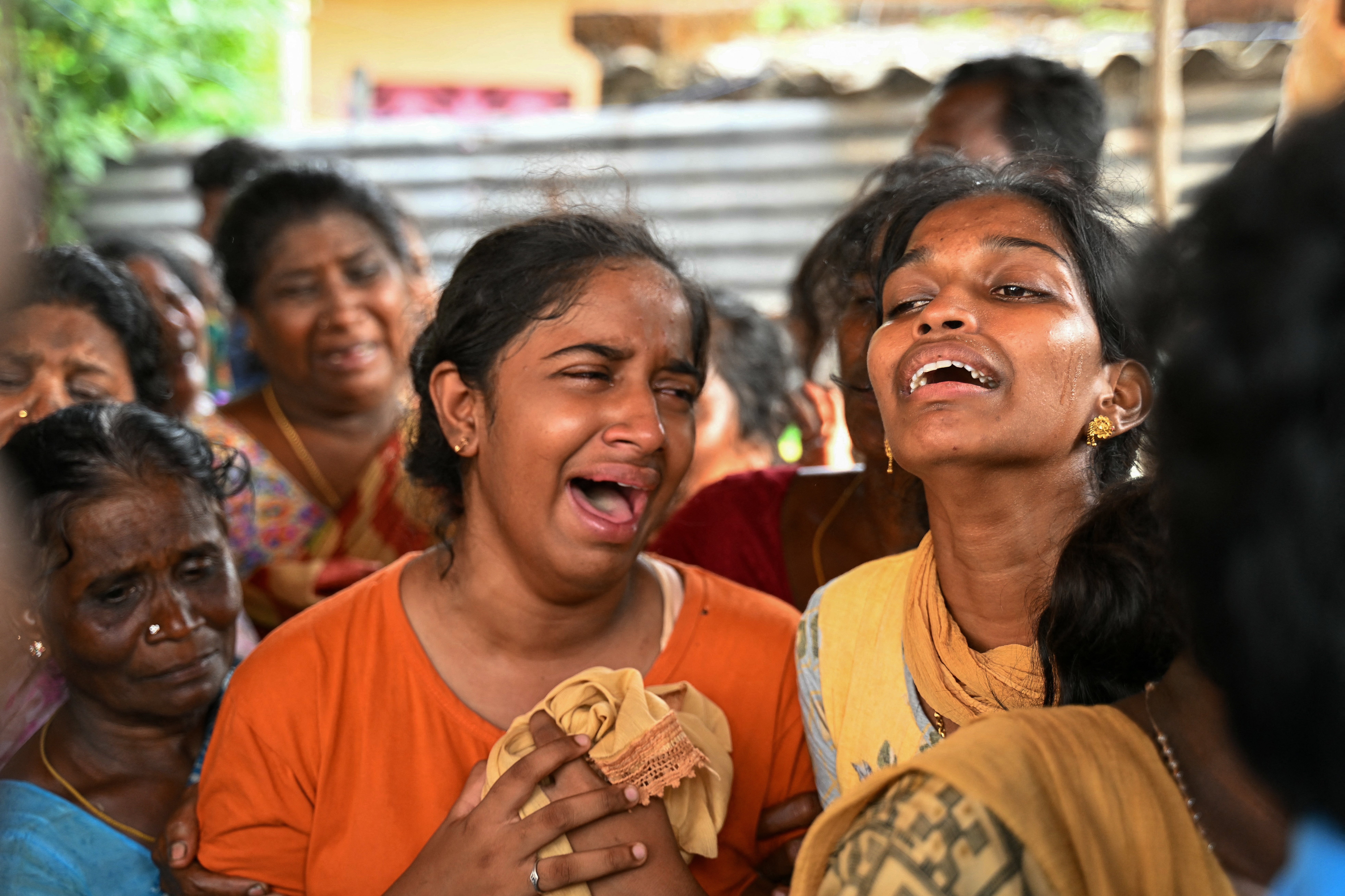 Relatives mourn the people who died after consuming toxic illegal alcohol in Kallakurichi in India’s Tamil Nadu state on 20 June 2024