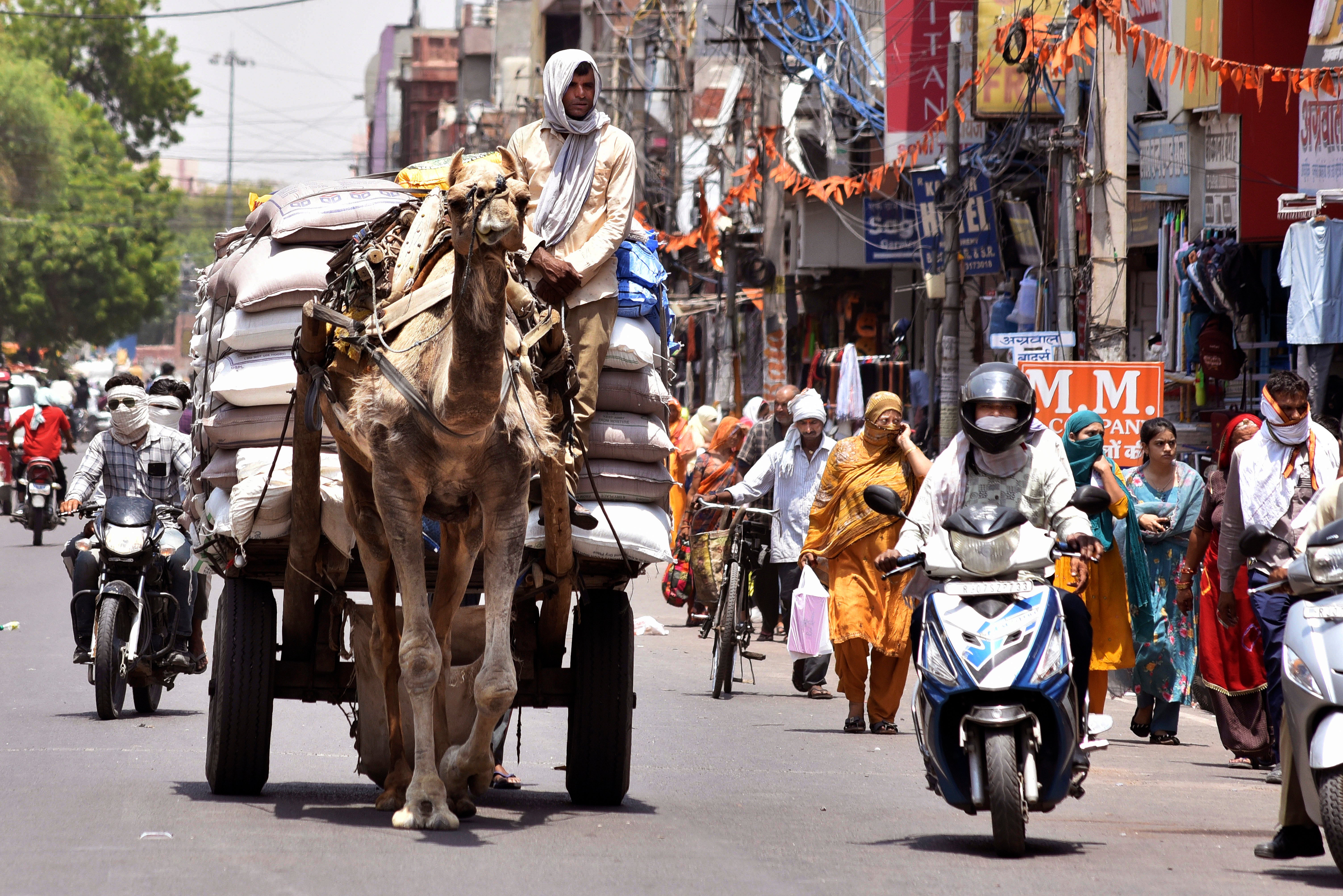 Commuters cover their faces with scarves to protect themselves from the harsh heat in Bikaner, Rajasthan