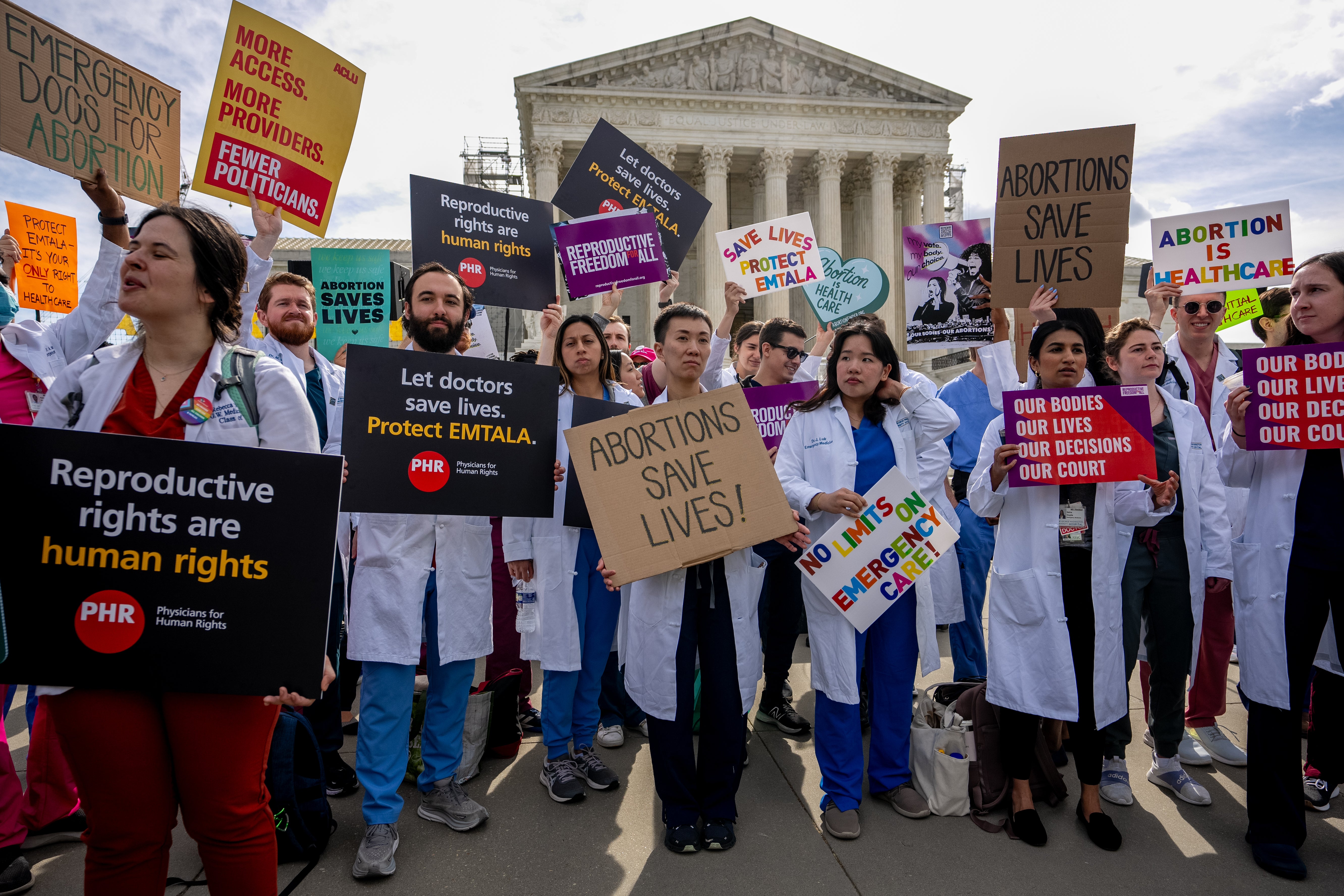 A group of doctors join abortion rights supporters at a rally outside the Supreme Court on April 24, 2024 in Washington, DC