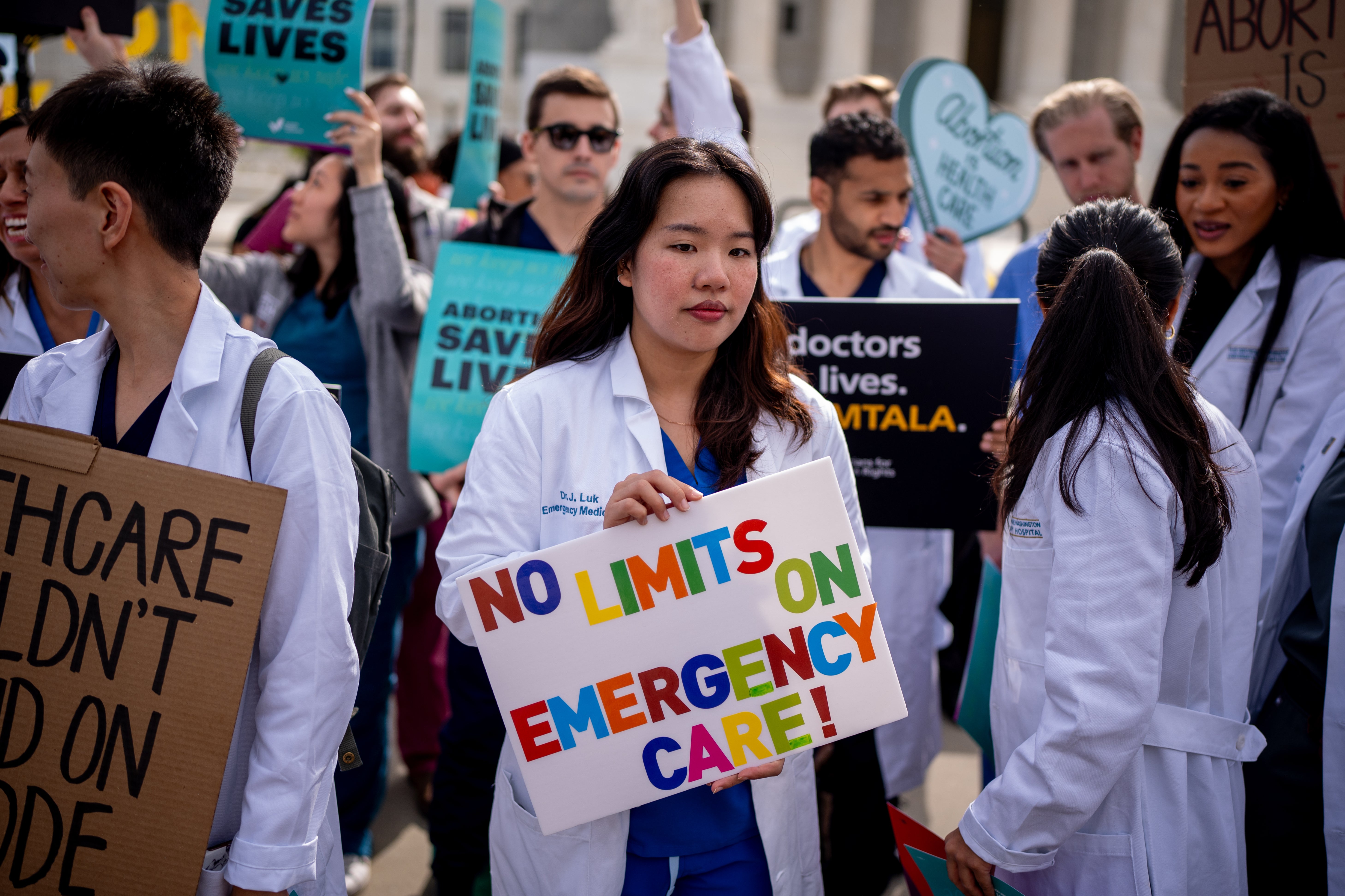 A group of doctors join abortion rights supporters at a rally outside the Supreme Court on April 24, 2024 in Washington, DC.