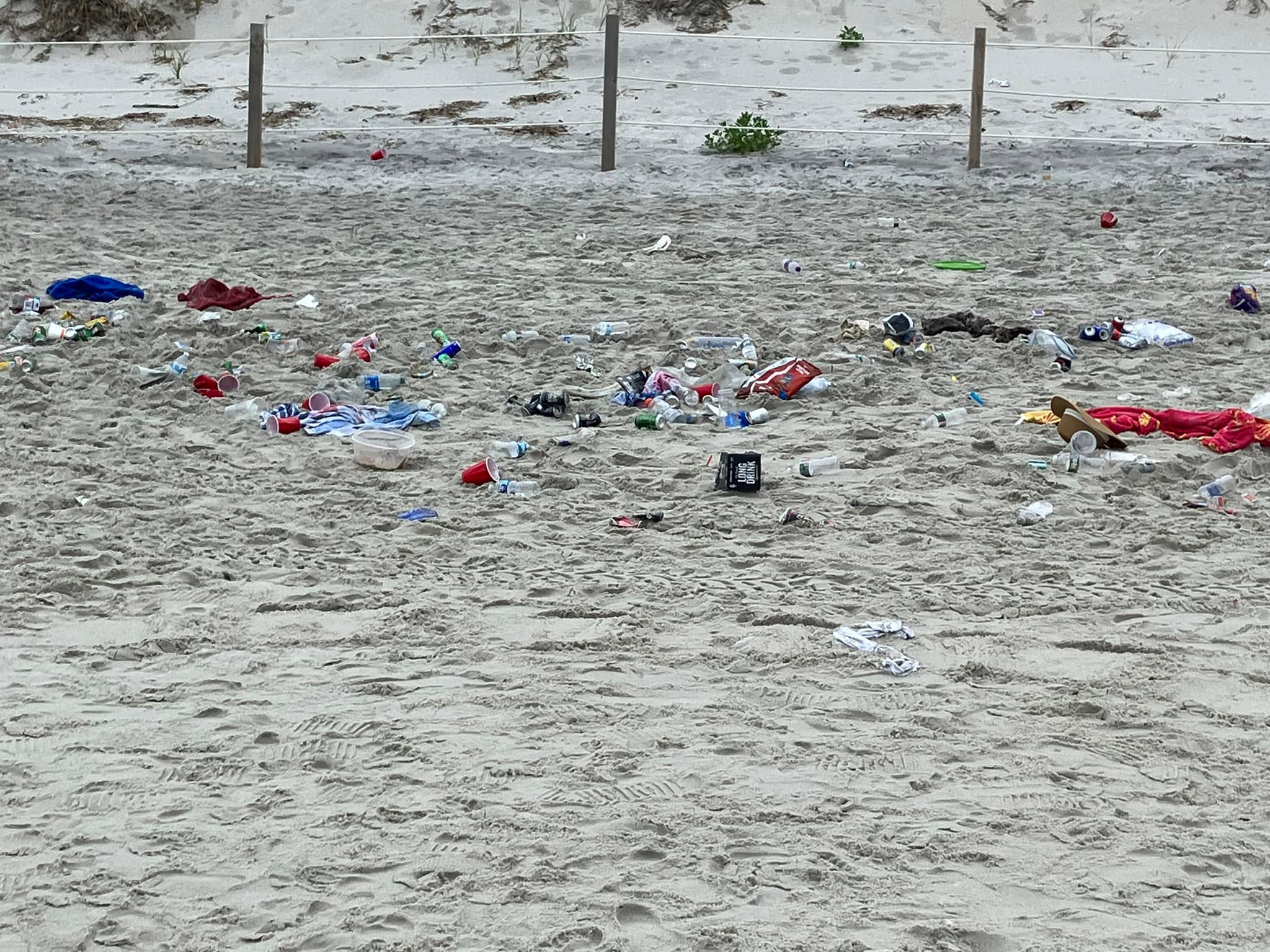 Trash left behind on July 4, 2023 on a beach in Dennis, Massachusetts. There will be no daily parking passes sold at Mayflower, Chapin, and Bayview beaches on the holiday this year, police say