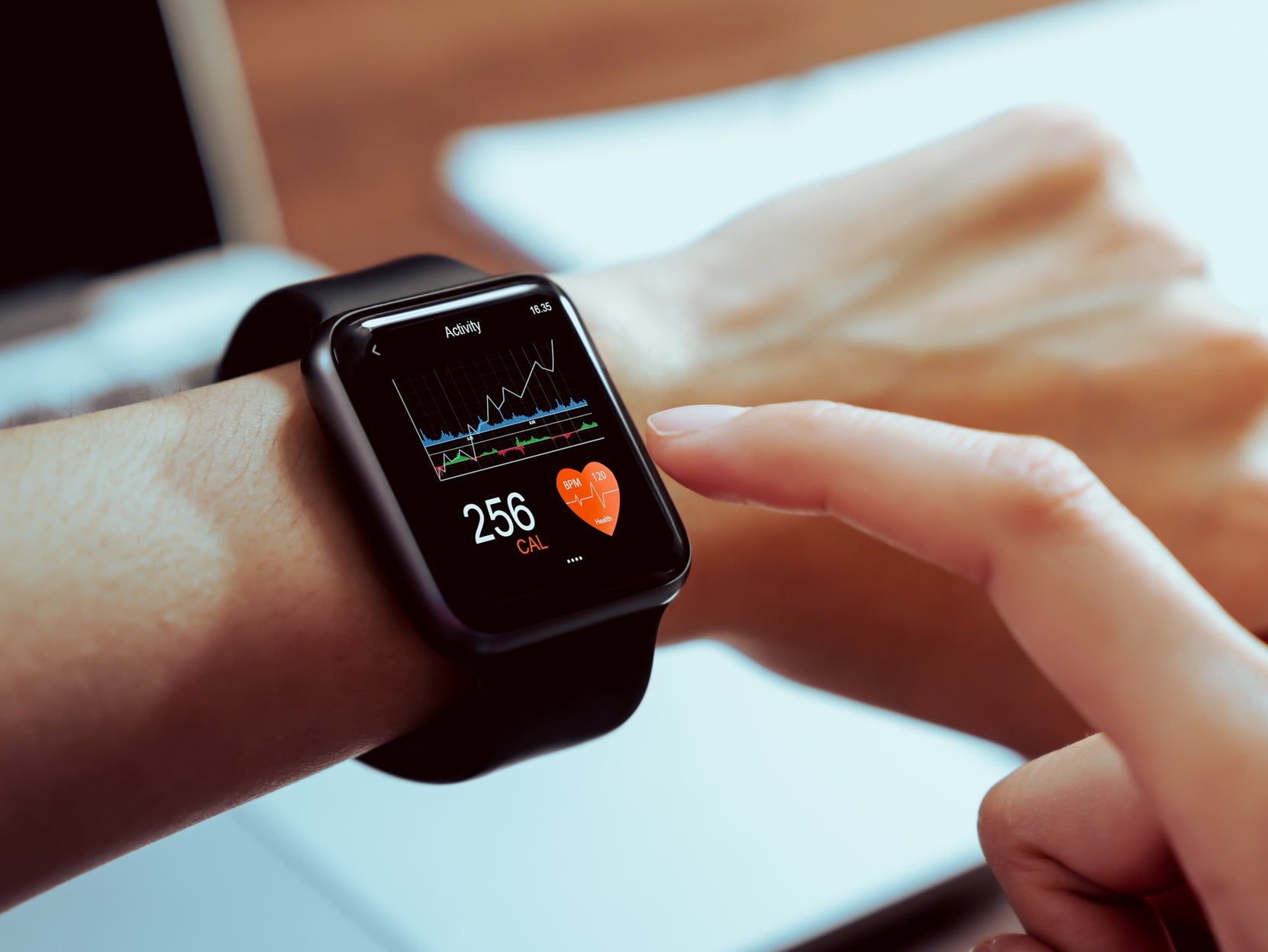 Close up of hand touching smartwatch with health app on the screen ( Getty Images )