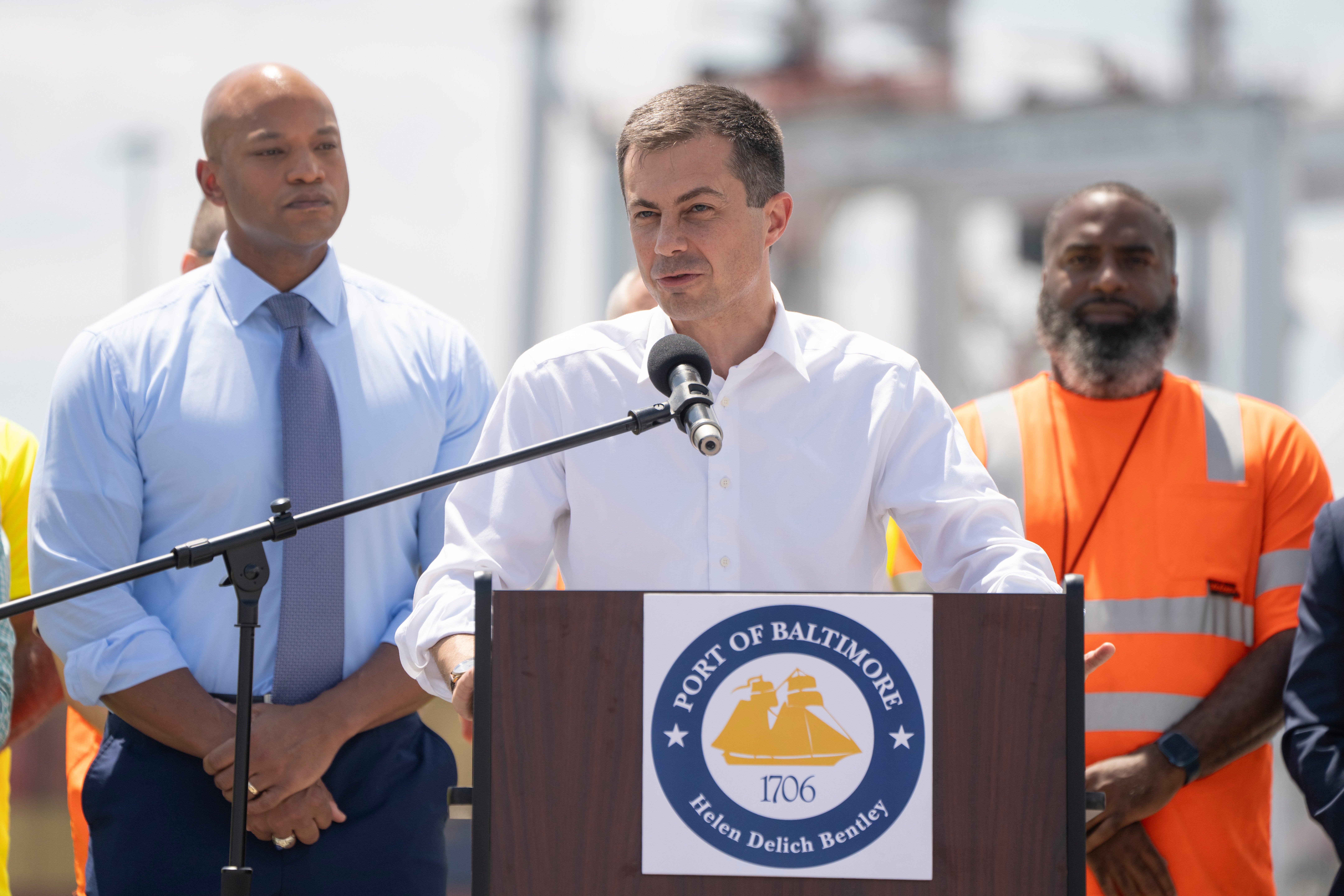 Transportation Secretary Pete Buttigieg, center, speaks during a news conference to mark the full reopening of the Port of Baltimore after the collapse of the Francis Scott Key Bridge in March, Wednesday, 12 June 2024