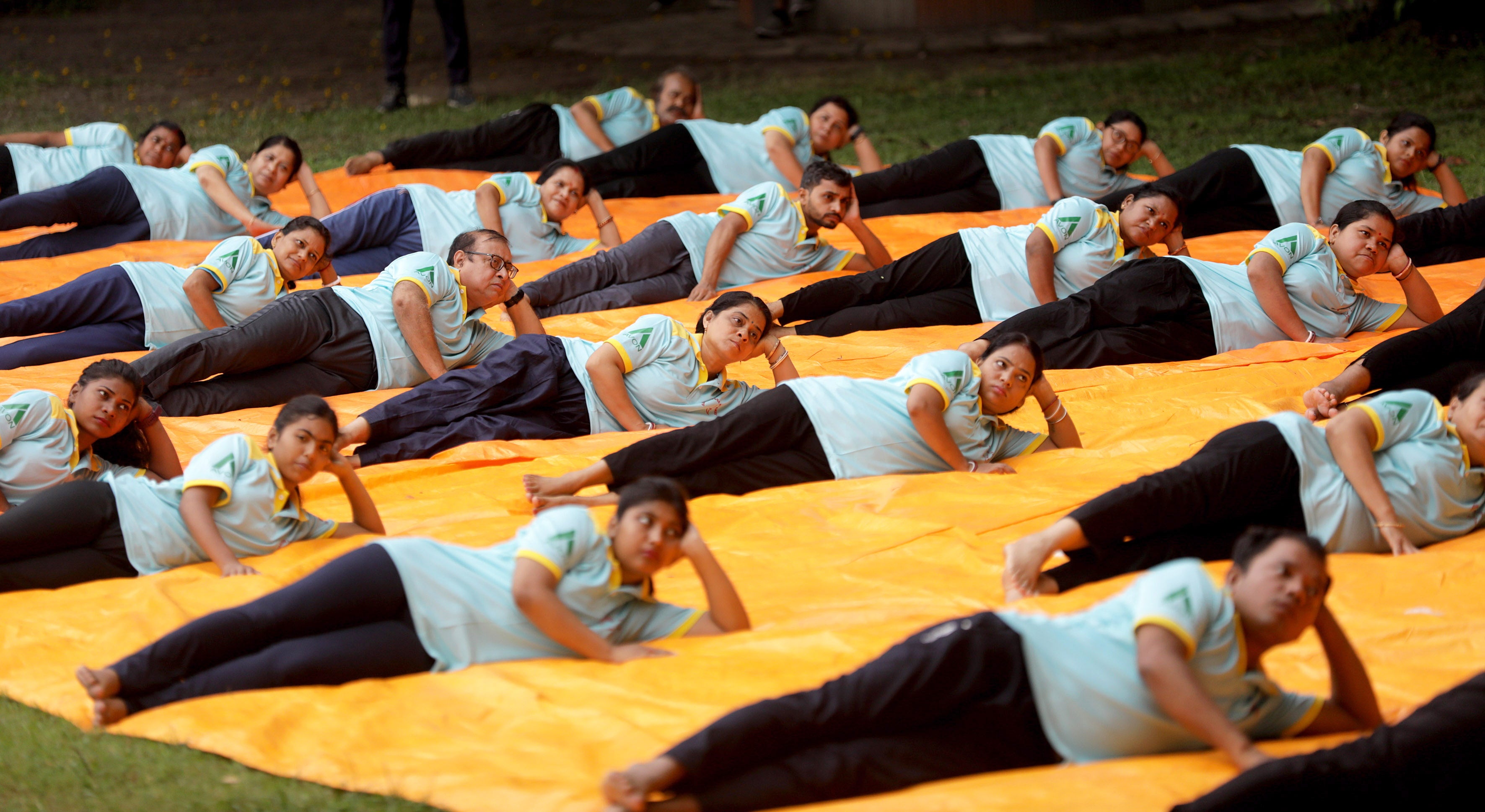 People perform yoga exercises during International Day of Yoga in Kolkata, India 21 June 2024