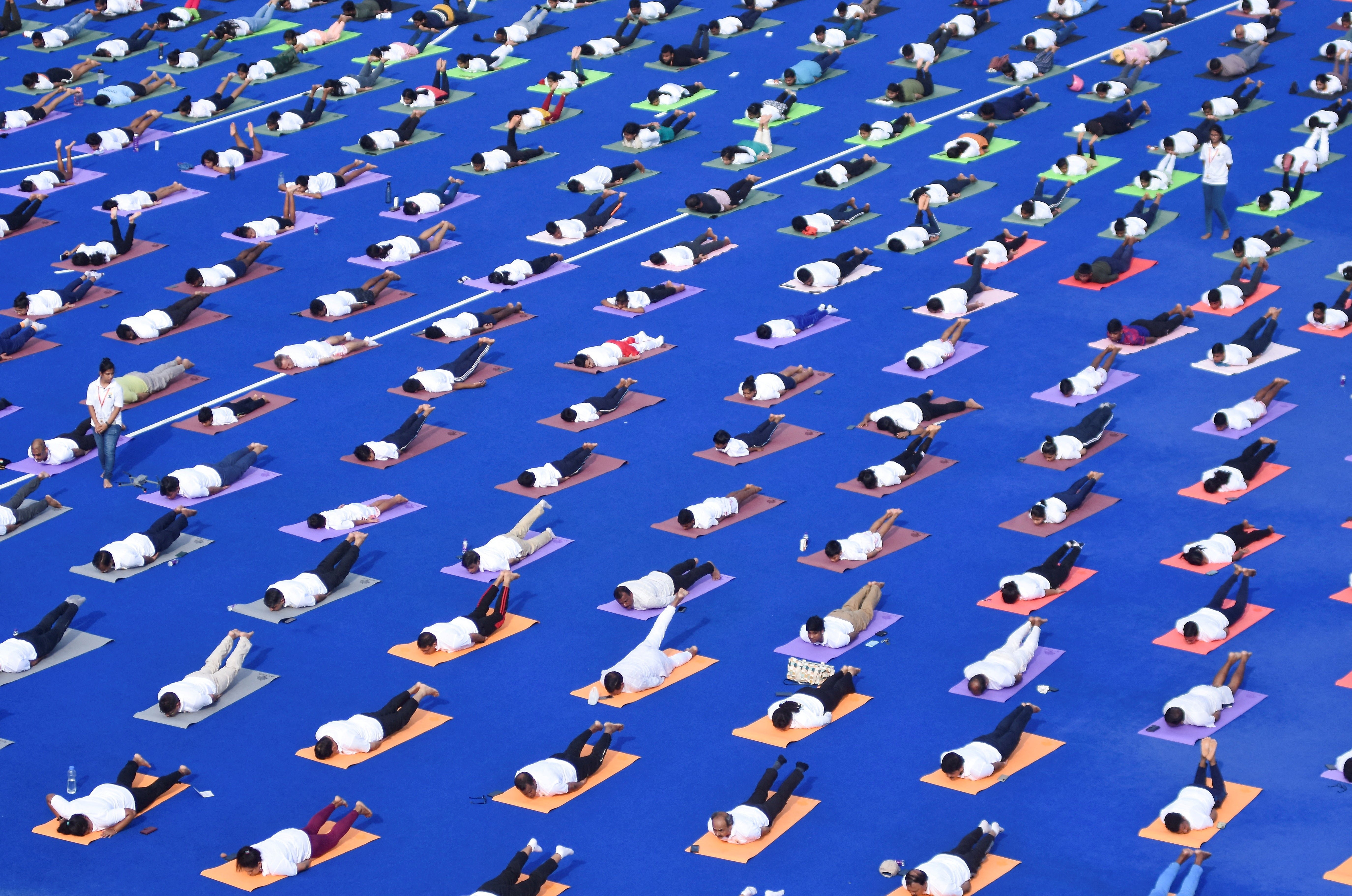 People perform yoga during the International Yoga Day at Kalinga Stadium in India on 21 June 2024