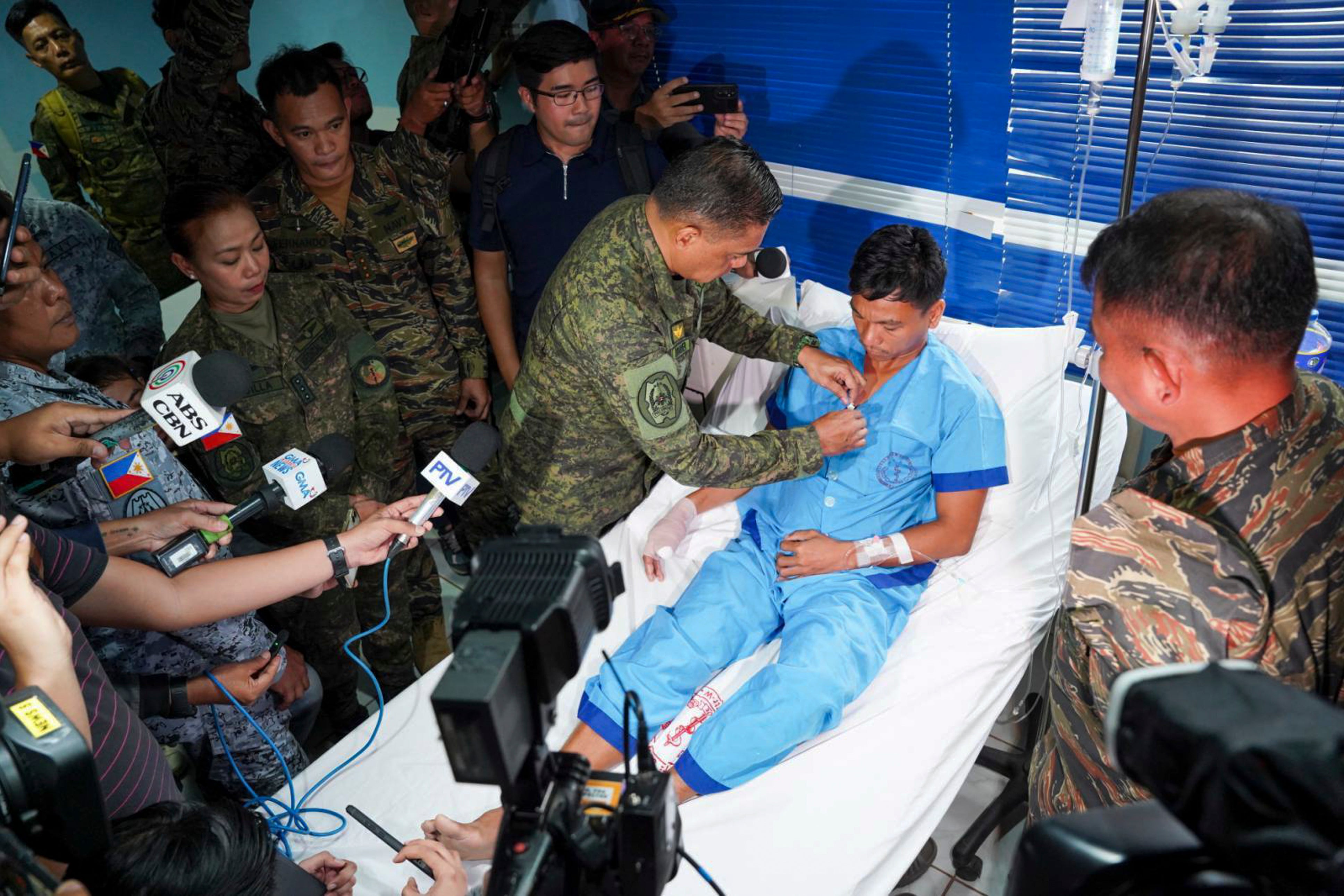 General Romeo Brawner Jr pins a medal on a sailor in Palawan province of Philippines on 19 June 2024