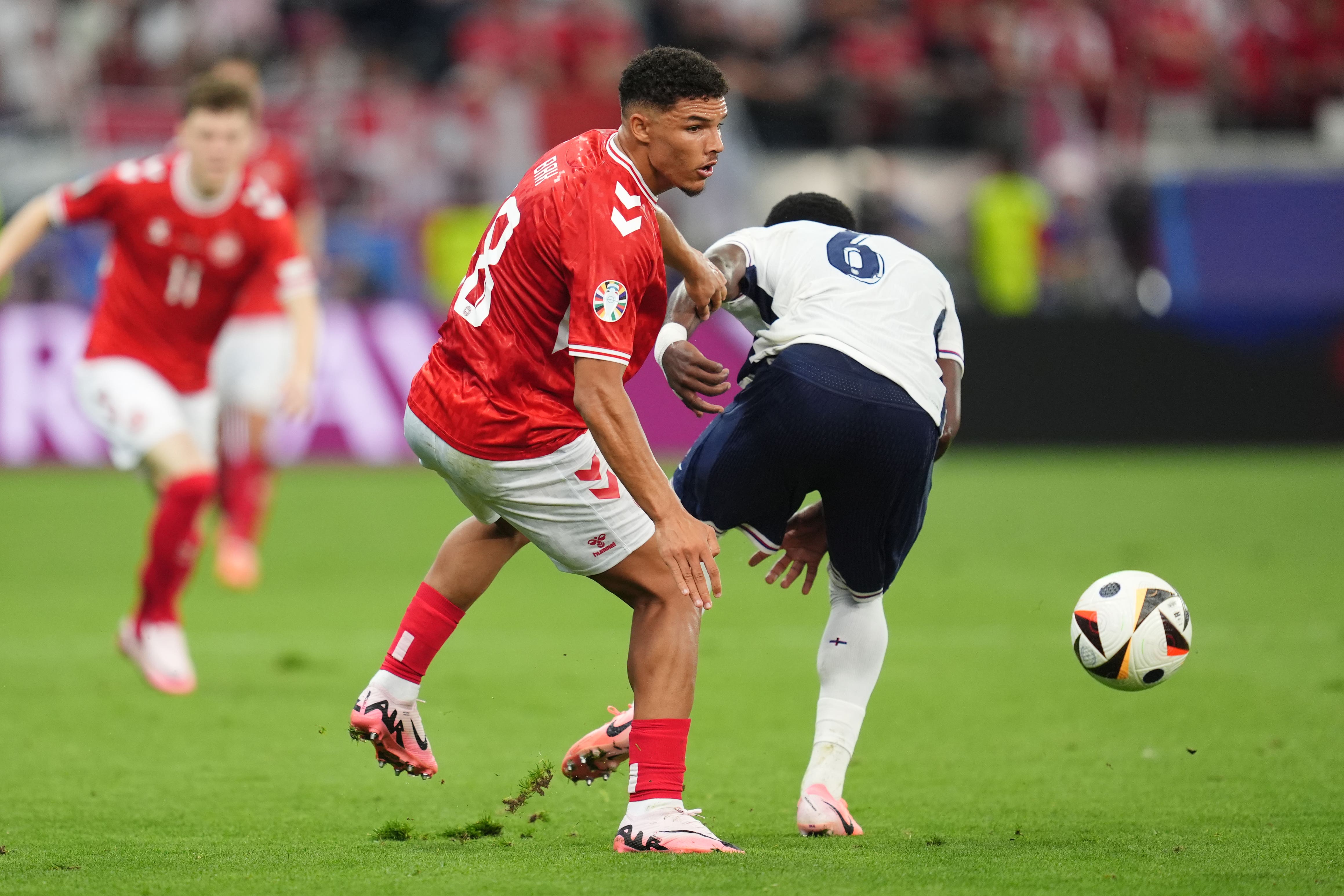 Denmark’s Alexander Bah and England’s Marc Guehi battle for the ball during the Euro 2024 match at the Frankfurt Arena (Adam Davy/PA)