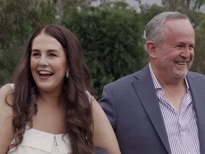 A bride tells her guests to put their phones away while walking down the aisle