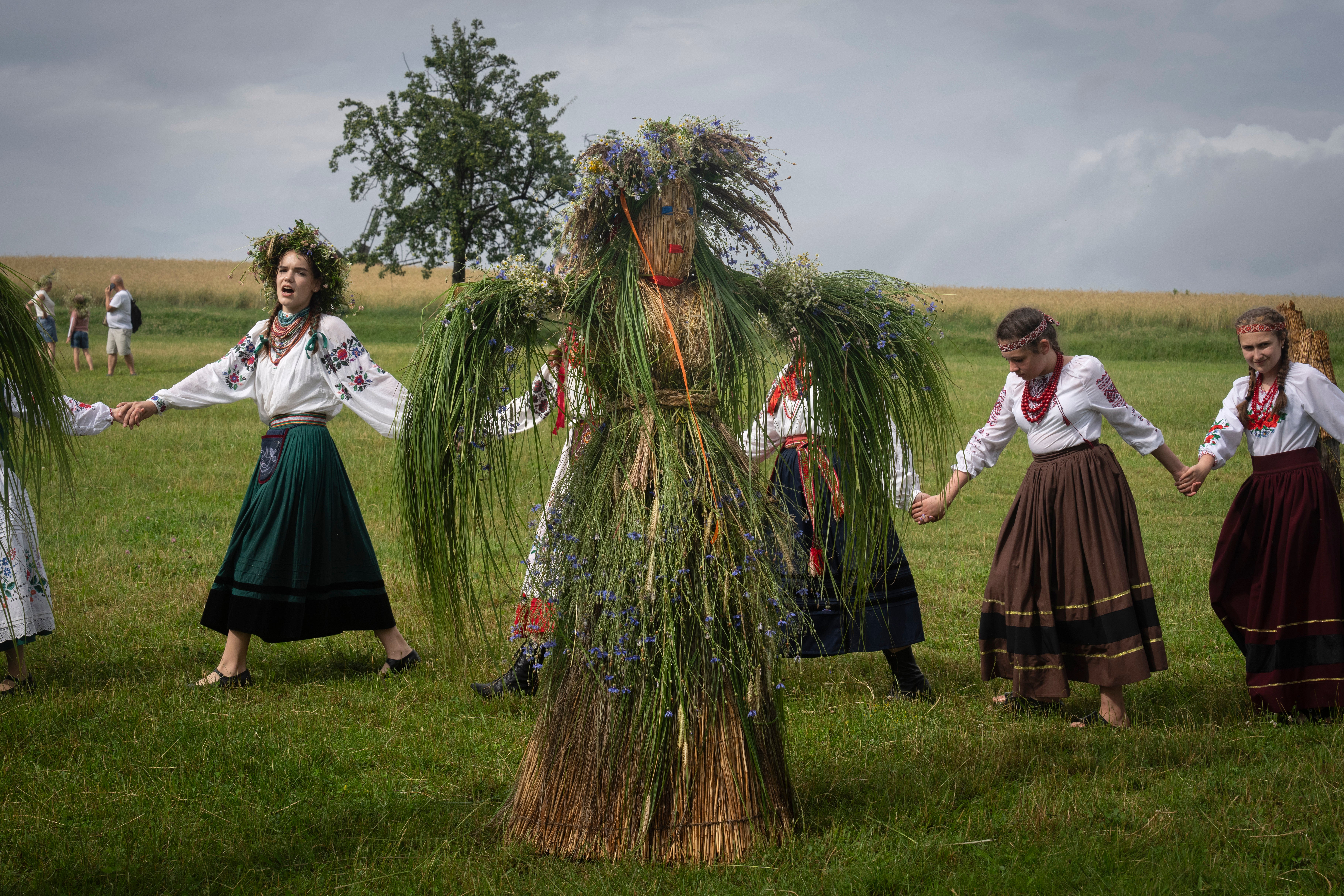 Ukrainian young women dressed in traditional clothing dance in circle at a traditional Midsummer Night celebration