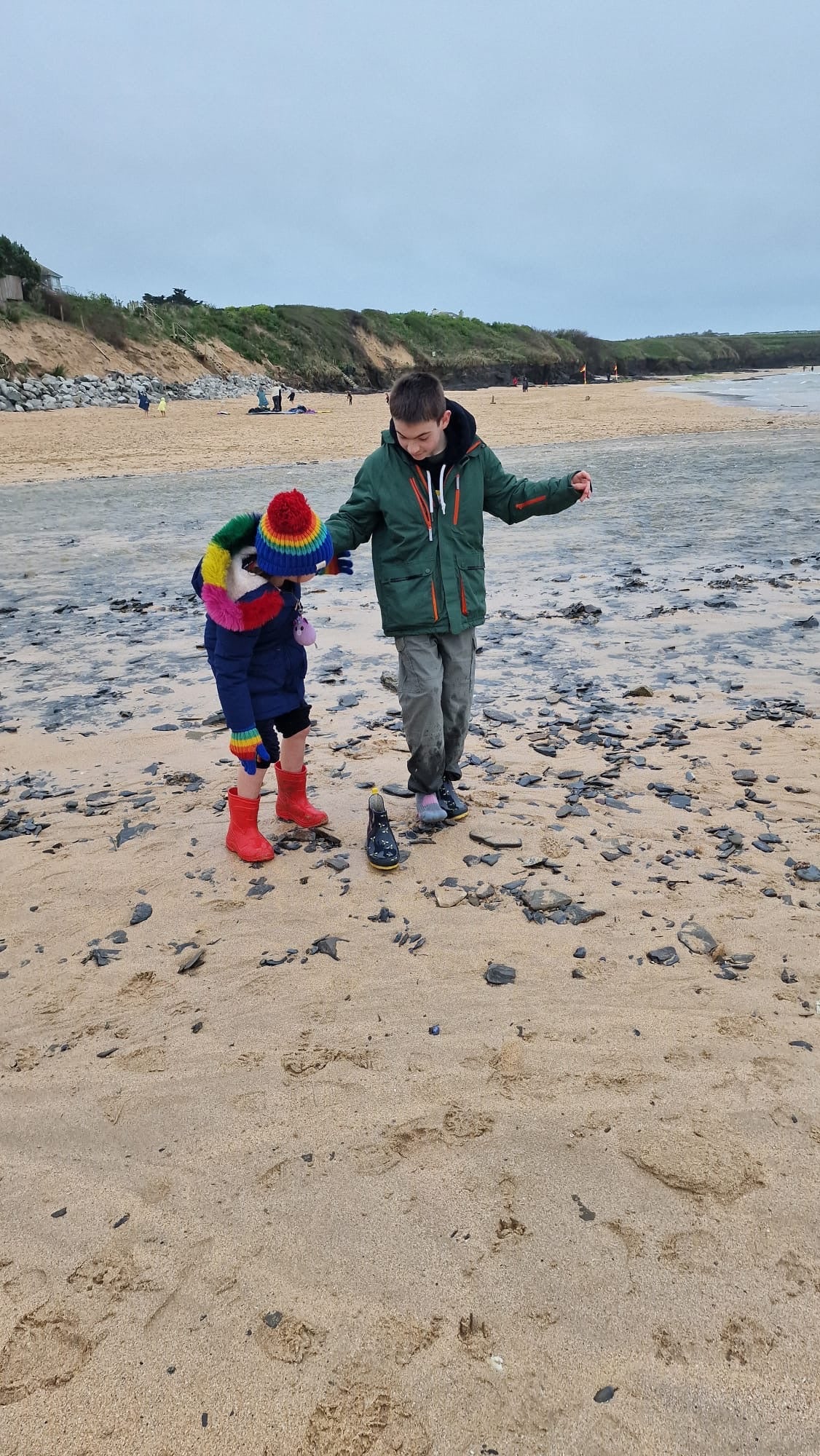 Oran at the beach with his sister after having device fitted in his brain to help epilepsy