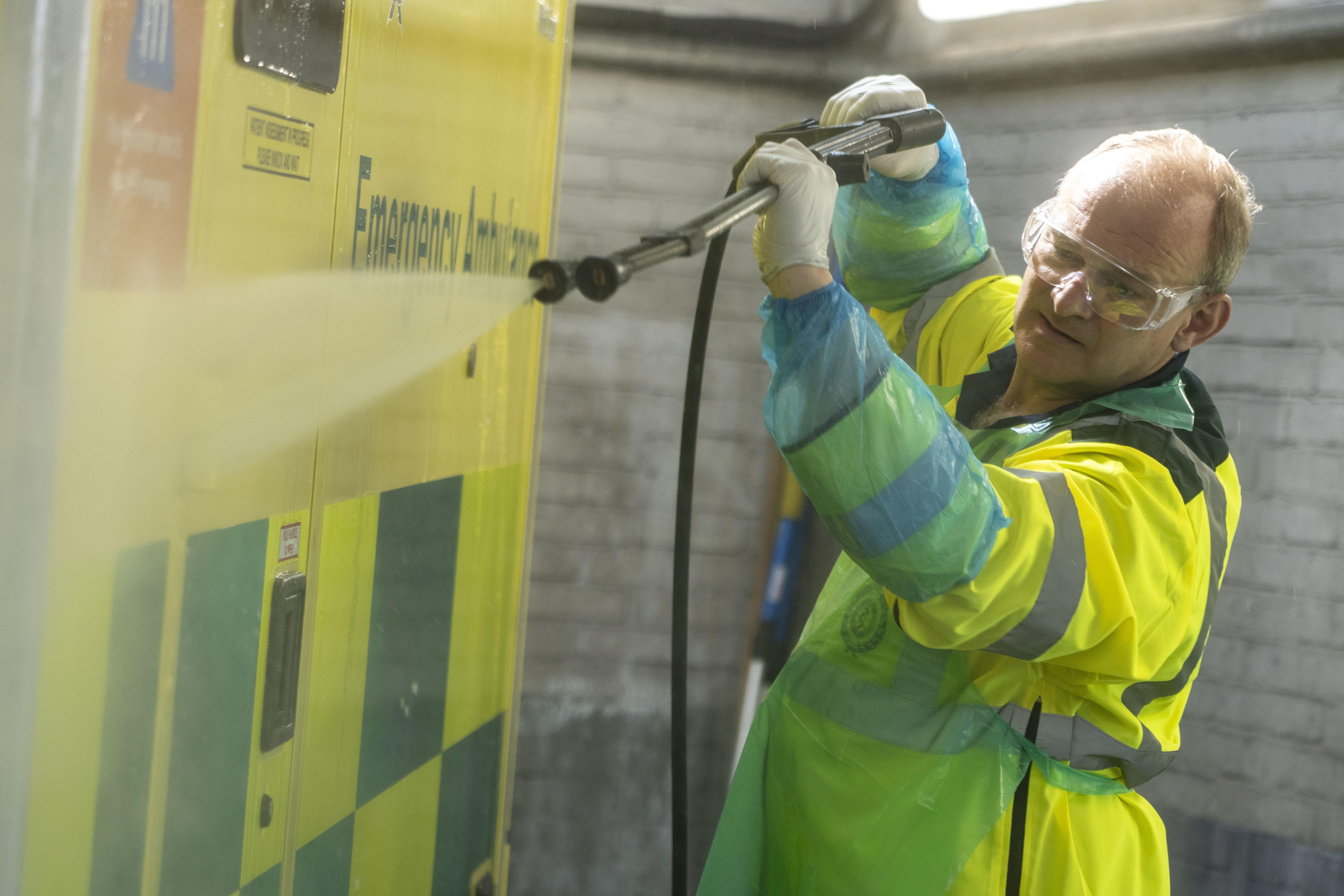 Lib Dem leader Sir Ed Davey washes an ambulance during a visit to Wimbledon Ambulance Station (Jeff Moore/PA)