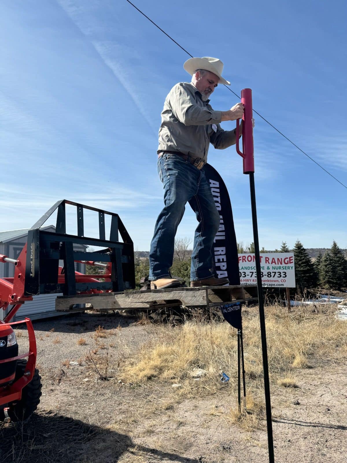 State Representative Richard Holtorf stands on a pallet raised by a steer loader in a picture posted by his campaign in February