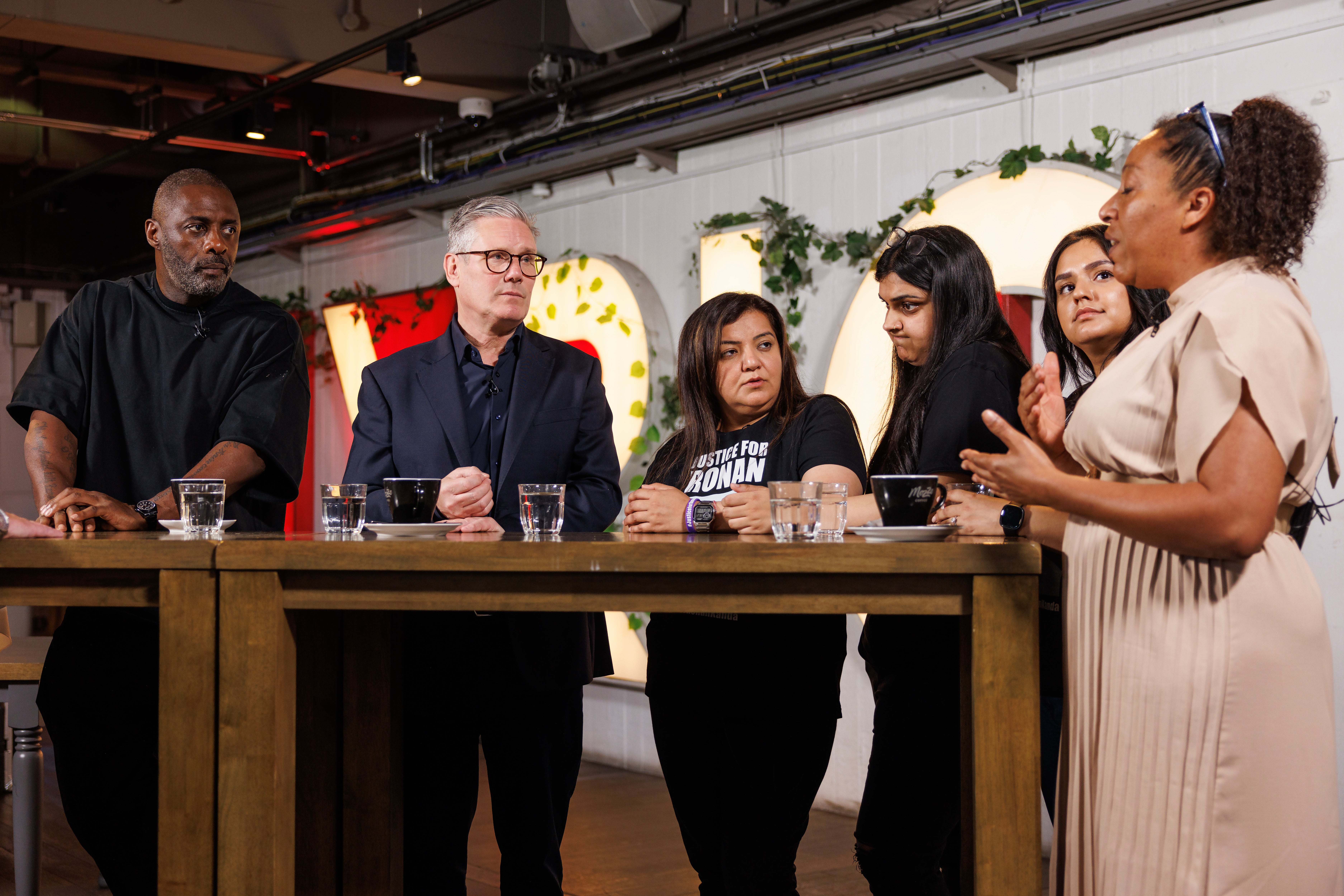 Pooja Kanda stands with Sir Keir Starmer and actor Idris Elba as they speak to the families of knife victims as part of a coalition to combat the crime
