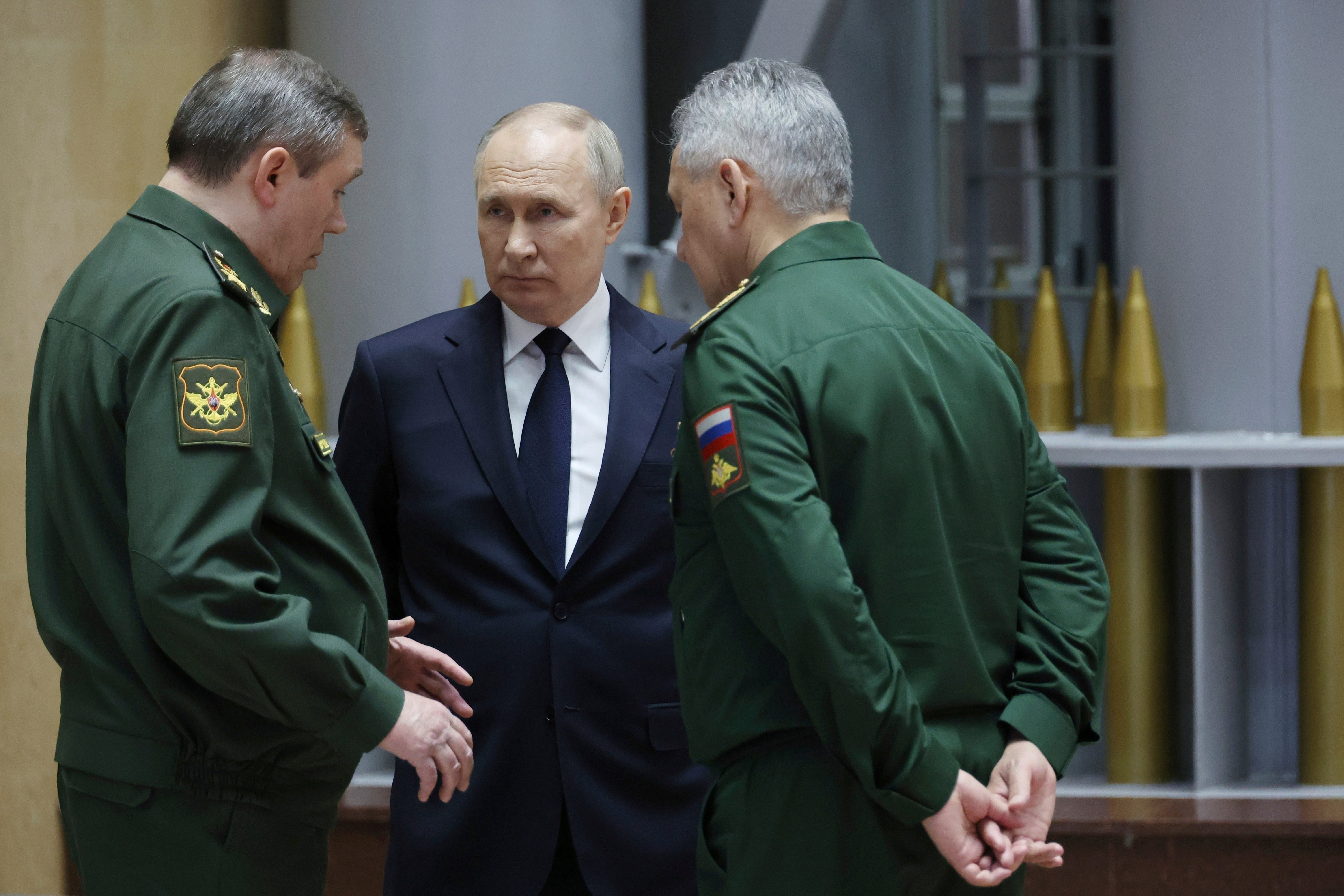 Russian president Vladimir Putin, centre, talks with the chief of the general staff Gerasimov, left, and defence minister Shoigu after a meeting in Moscow late last year