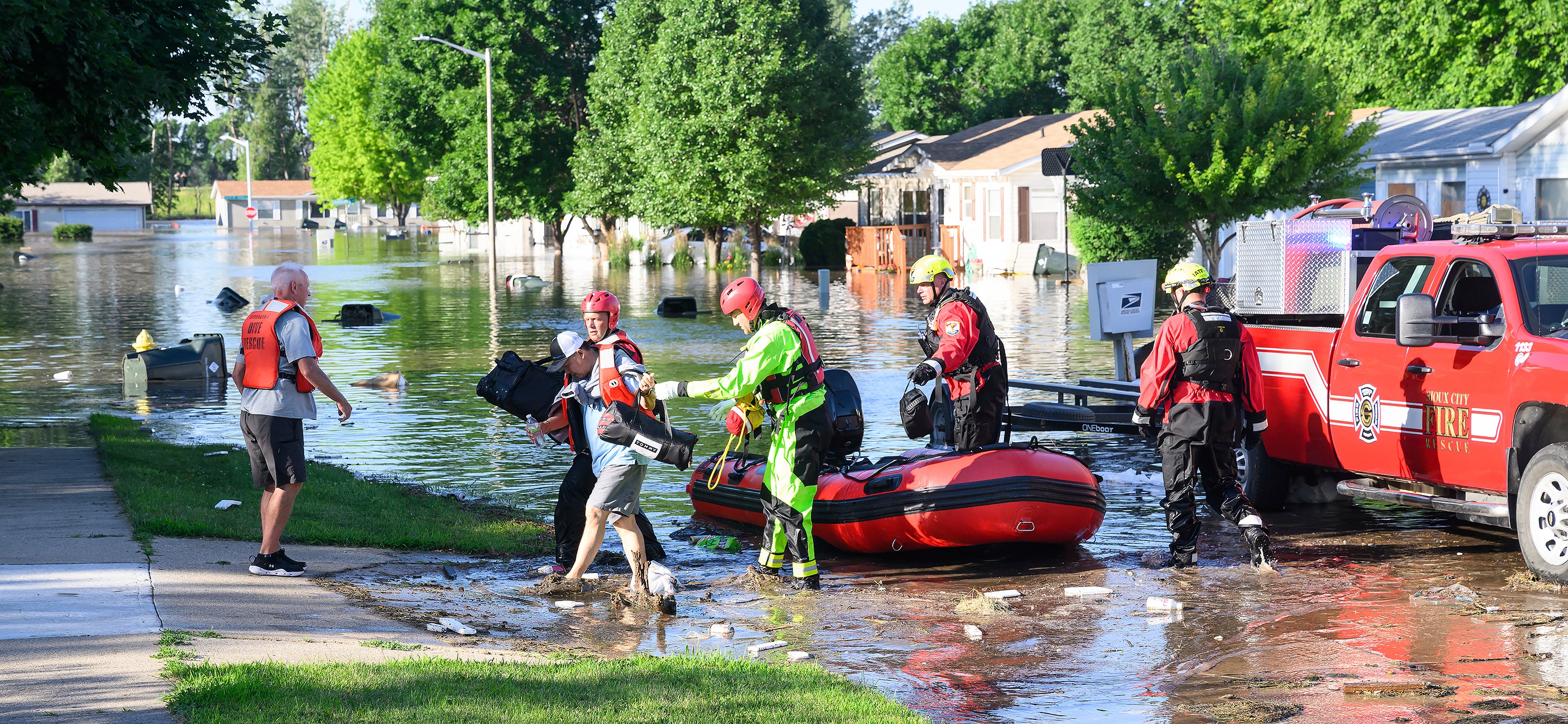 Officials perform a water rescue in Sioux City, Iowa on Monday as floodwaters put thousands in danger