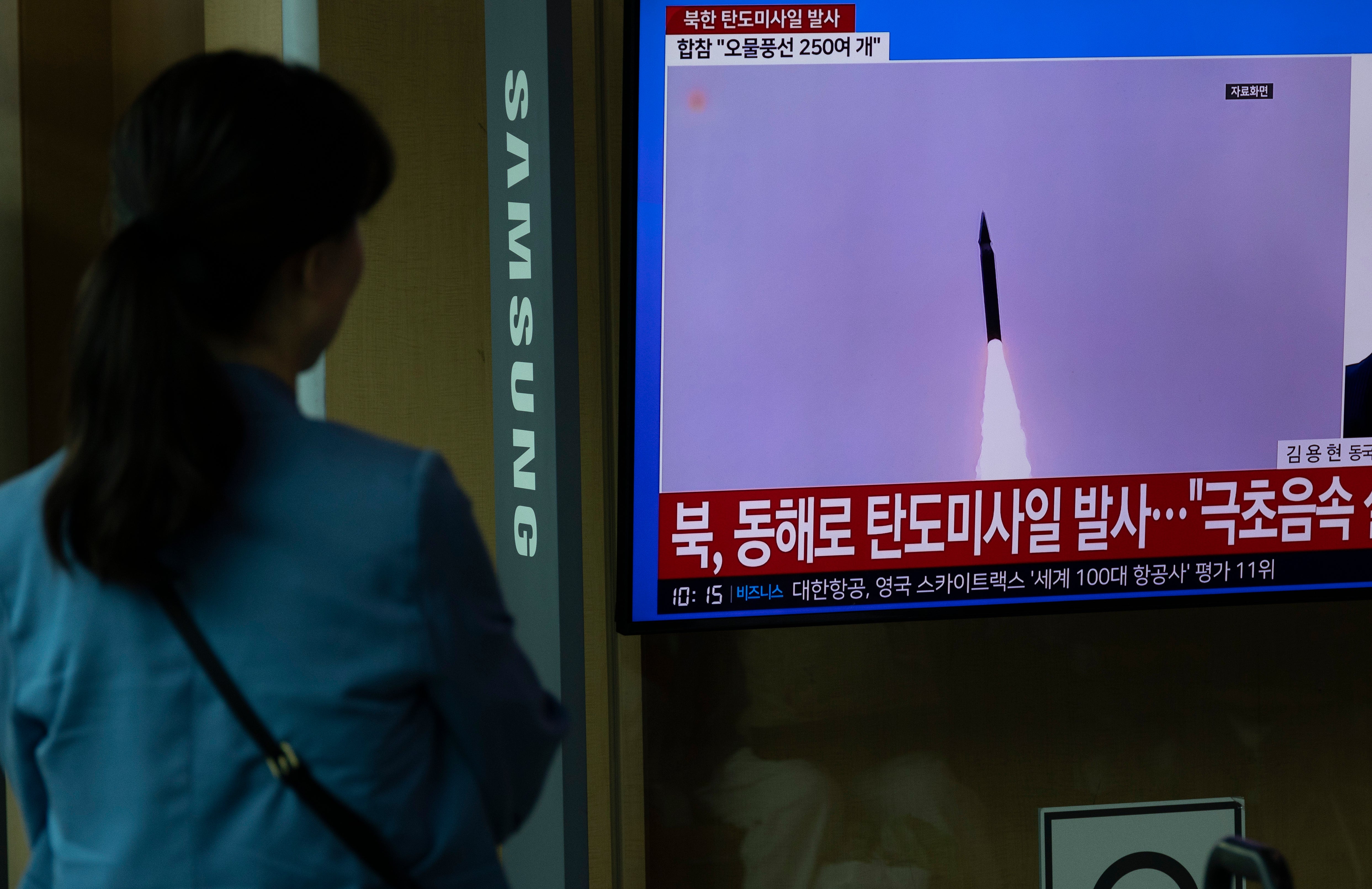 People watch the news at a station in Seoul, South Korea, 26 June 2024