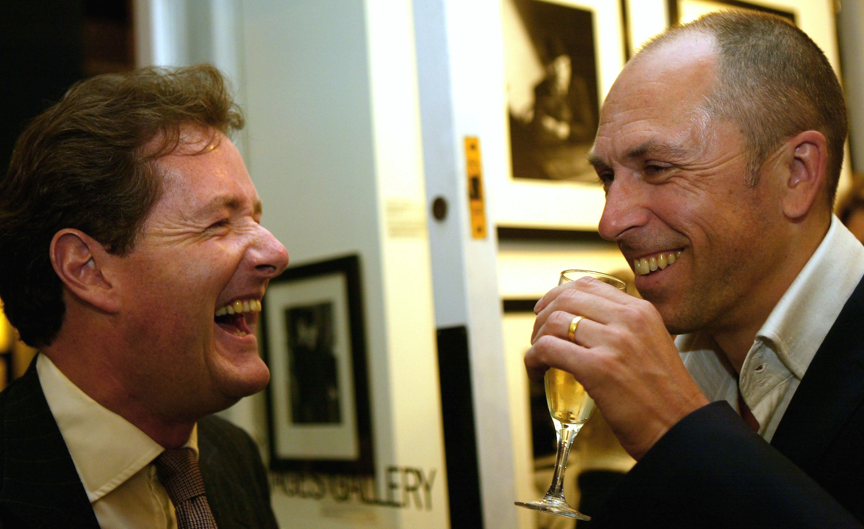 Piers Morgan and Jones having a laugh at GQ’s 50 Best Dressed British Men Ever exhibition in 2004