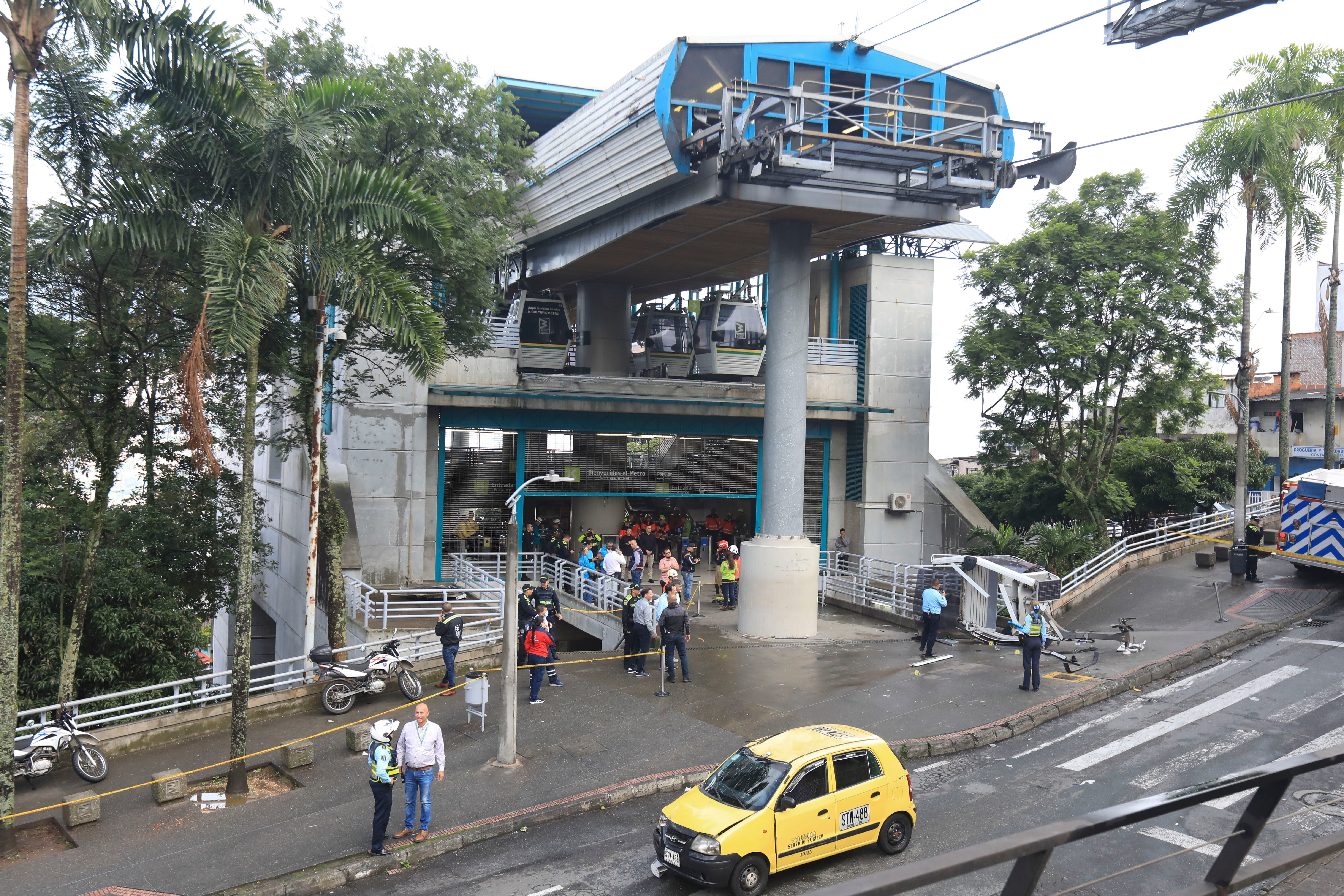 A cable car lays on the ground, right, after it fell in Medellin, Colombia, Wednesday, June 26, 2024