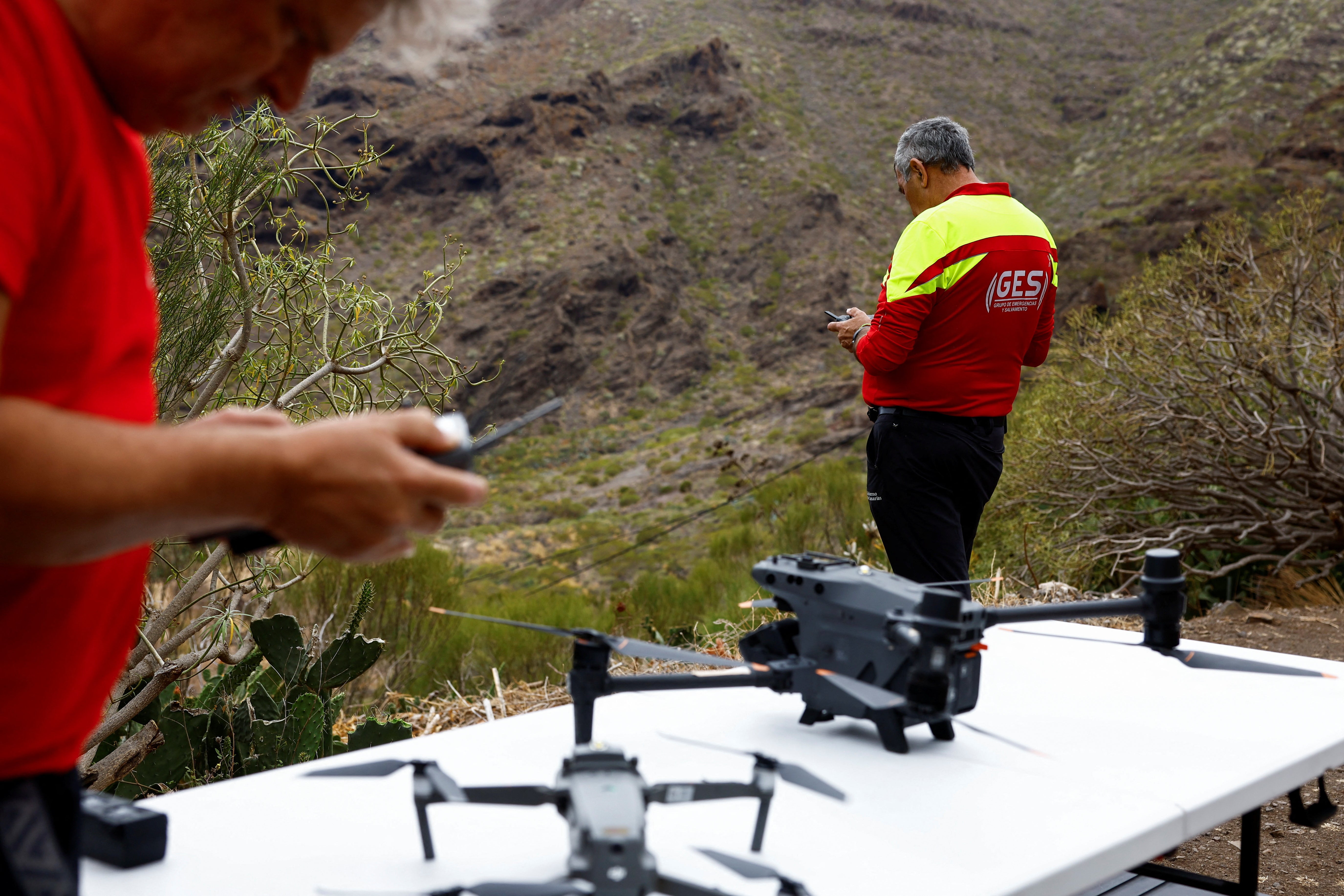 Rescuers carry out a search operation with drones