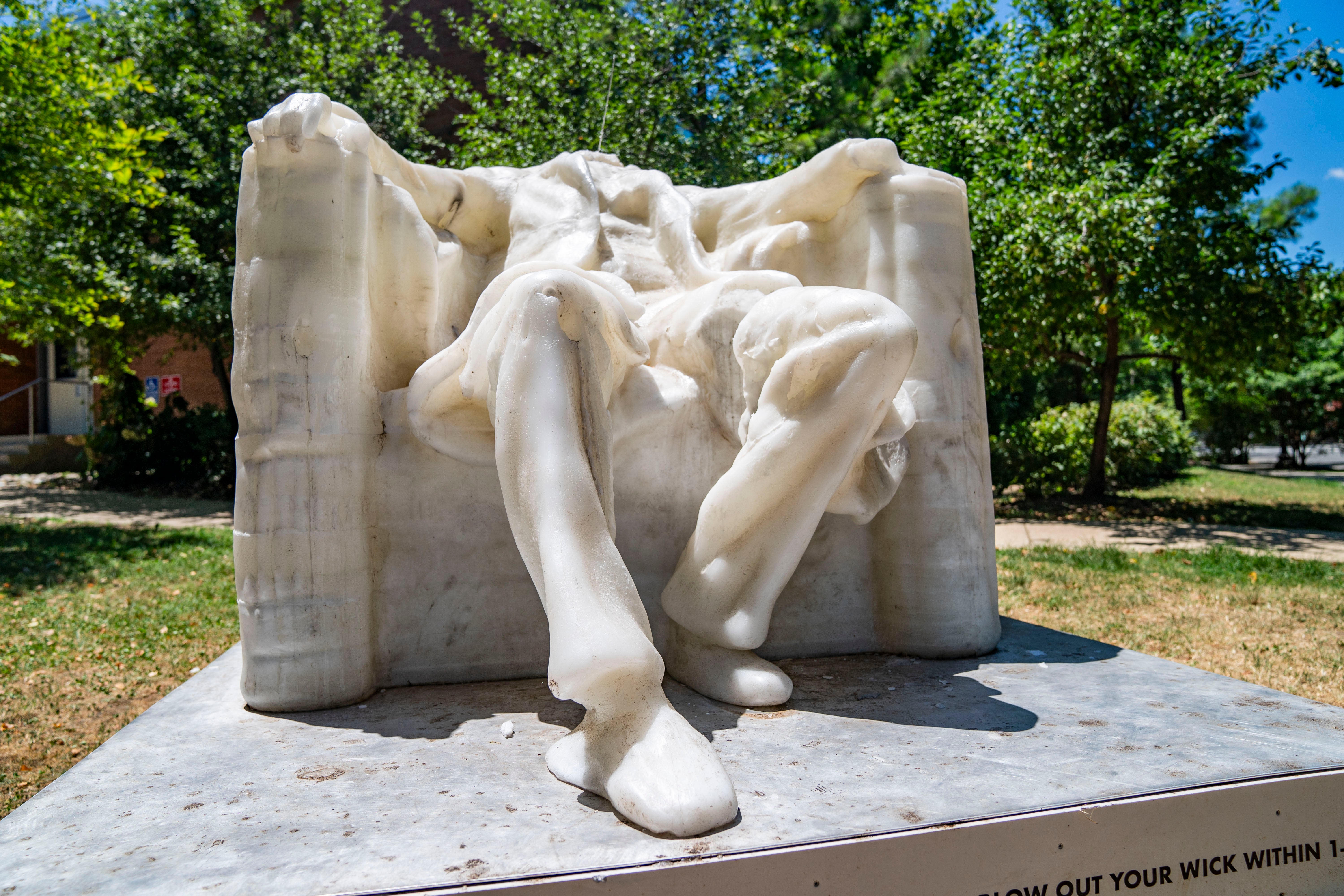 A wax replica of the Lincoln Memorial statue melts during a heat wave in Washington, DC, on June 24, 2024. The statue is a part of the The Wax Monument Series by Virginia based artist Sandy Williams IV