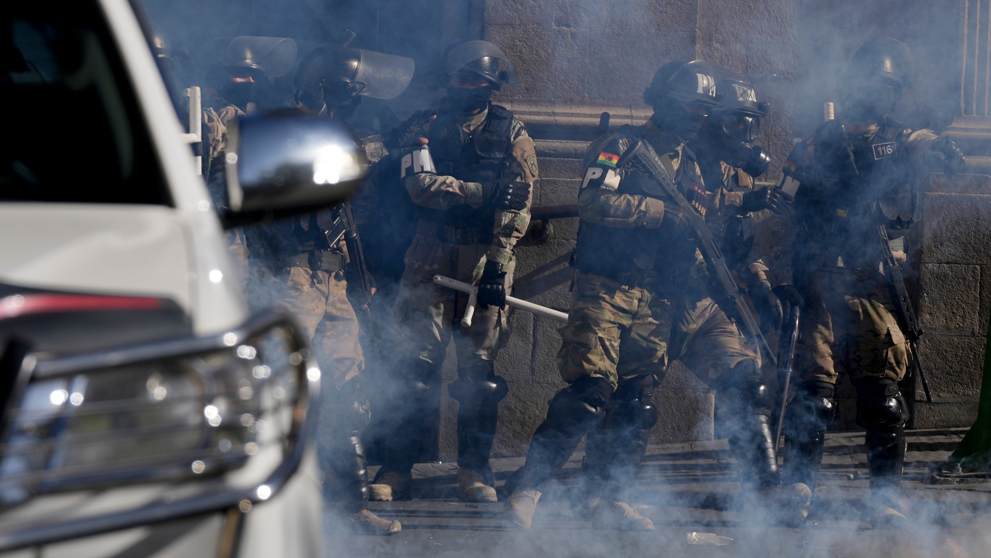 Military Police stand amid tear gas they fired outside the presidential palace in Plaza Murillo in La Paz, Bolivia, Wednesday, June 26, 2024