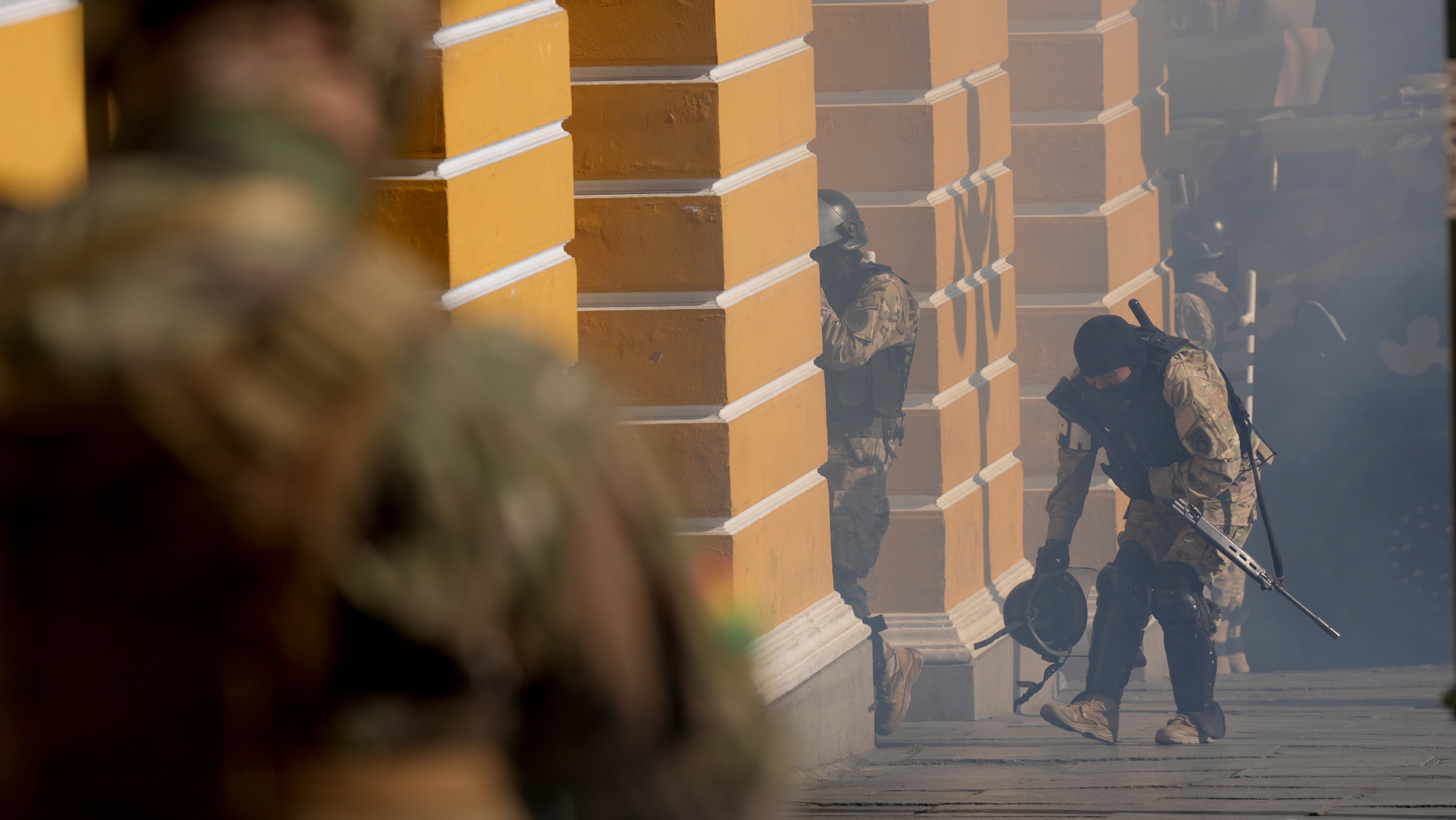 Soldiers walk amid tear gas they fired outside the Legislative Assembly in Plaza Murillo in La Paz, Bolivia, Wednesday, June 26, 2024