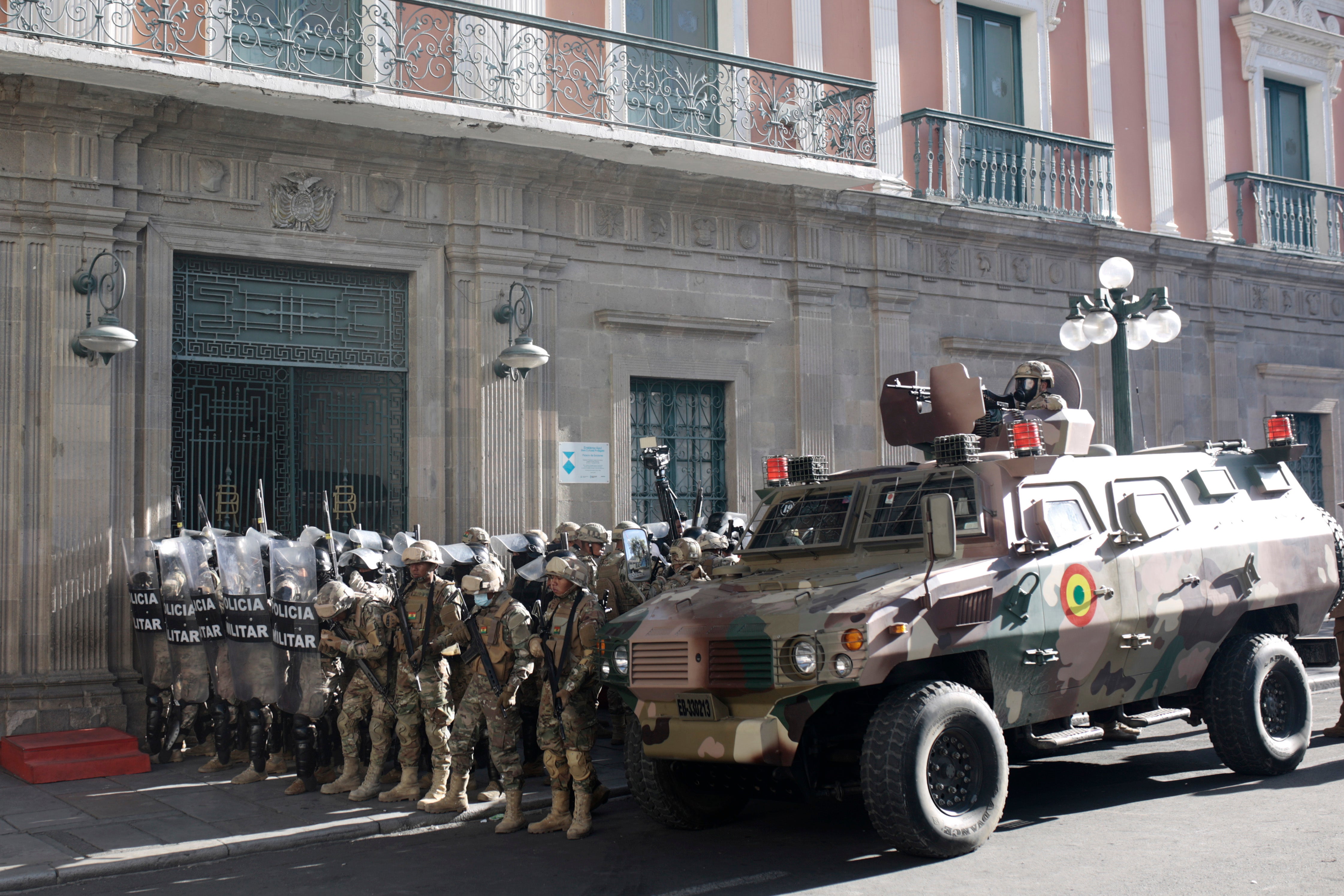 Military members stand guard with an armored truck outside the government palace at Plaza Murillo on June 26, 2024 in La Paz, Bolivia